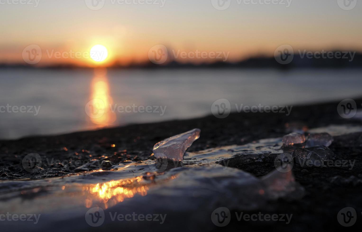 Colorful sunset reflection on a frozen water surface photo