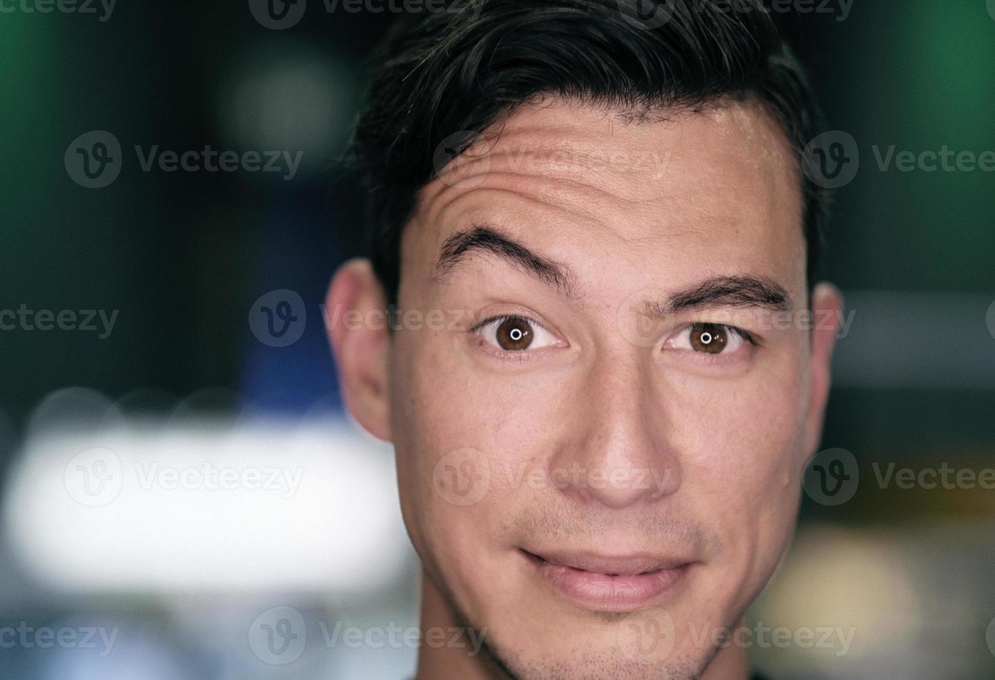 Closeup of a man raising one eyebrow photo