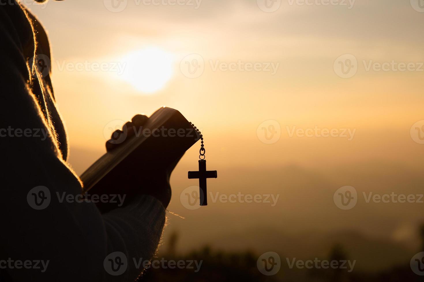 Hands of a Christian man holding a bible while praying to God, Religious beliefs, Copy space. photo