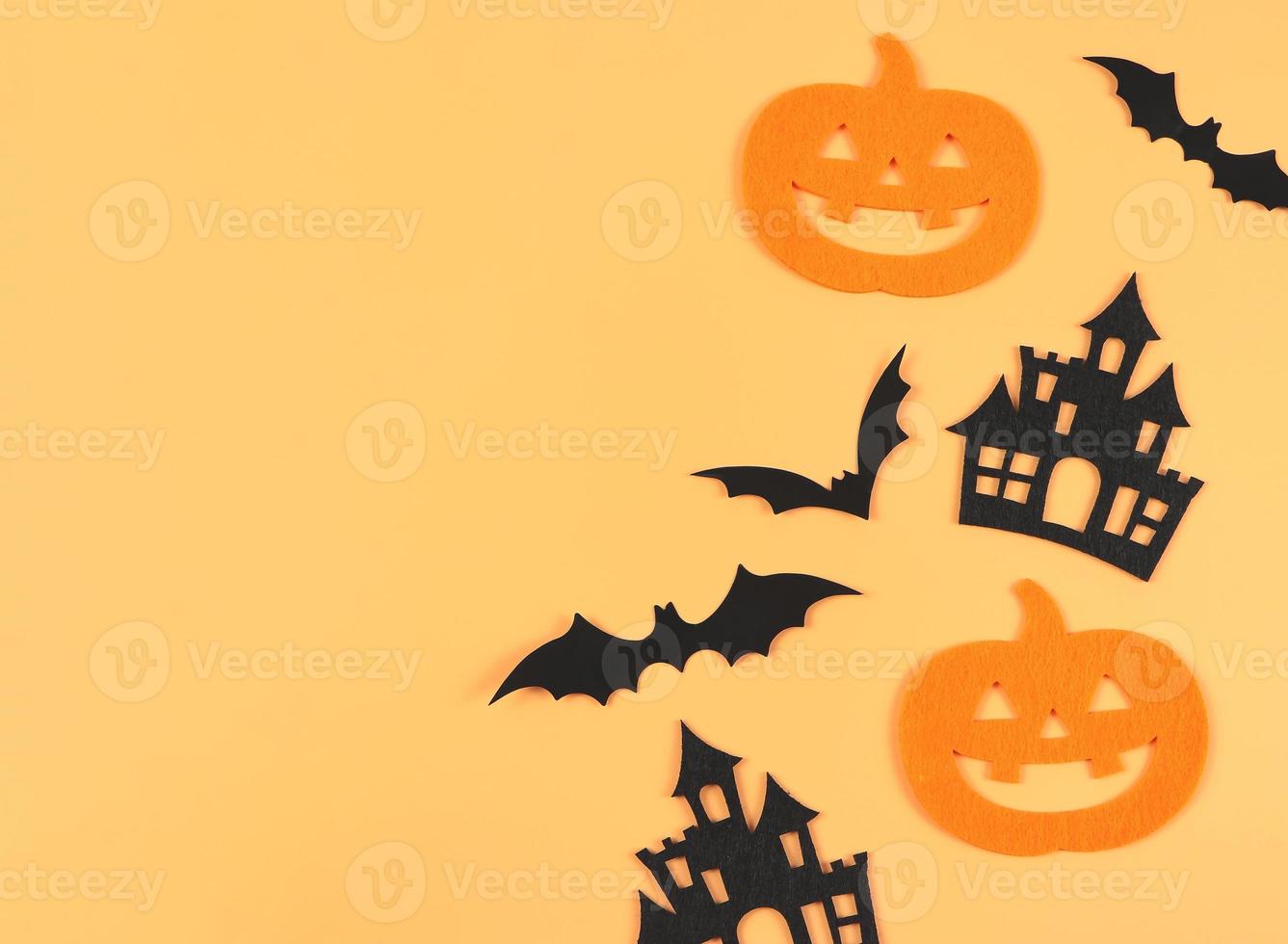 decorations for Halloween holiday, Halloween pumpkins, castles and bats on orange color background. photo