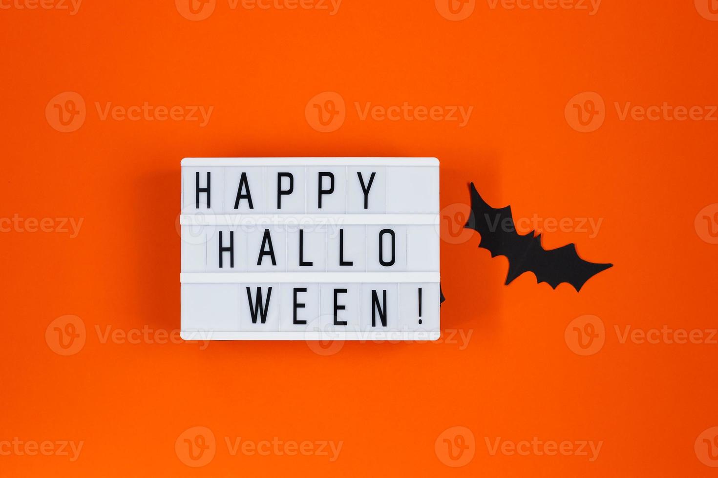 Halloween concept. Festive decorations. Bats on orange background. photo