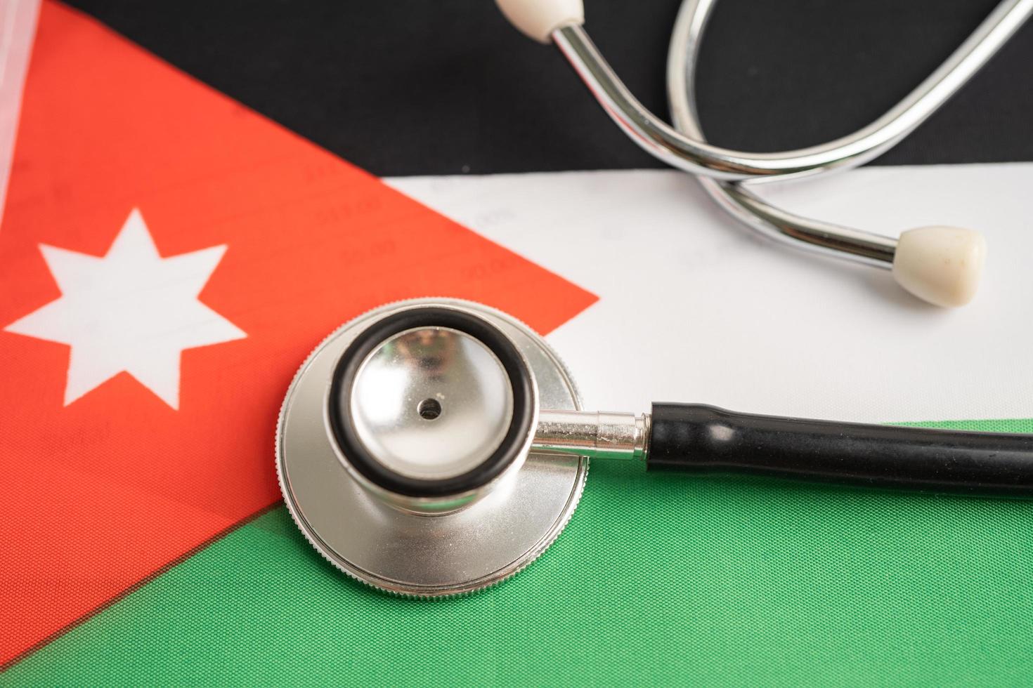 Black stethoscope on Jordan flag, Business and finance concept. photo