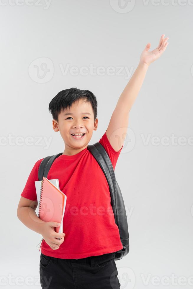 Back to school. Happy exciting child boy ready to study with backpack isolated on white. Kid win and jump with hand up photo