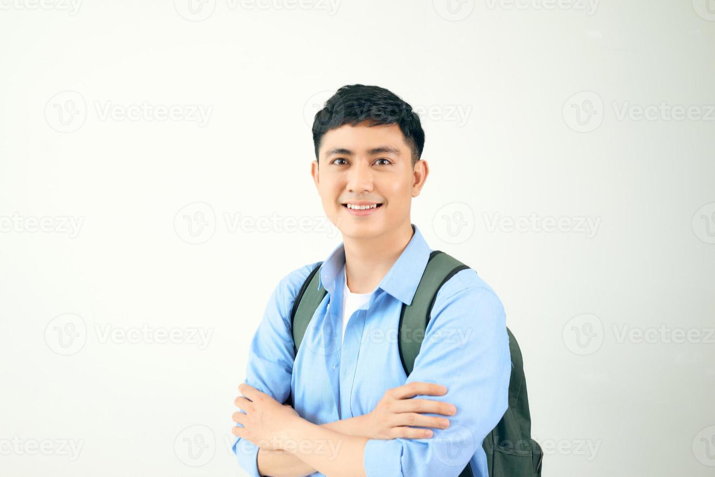 Handsome young man smiling and standing confidently on white background photo