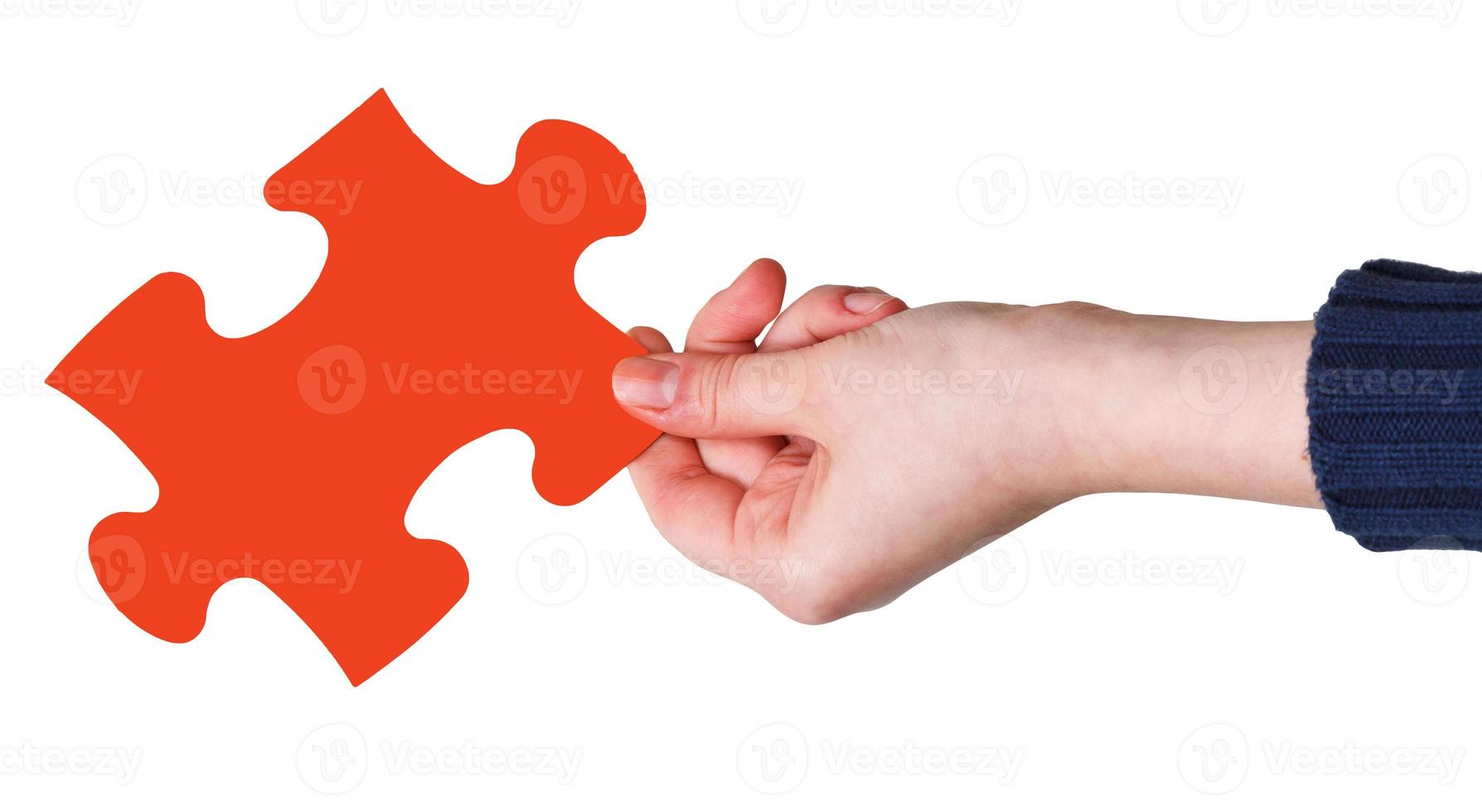 female hand with red puzzle piece photo