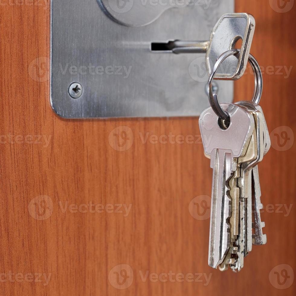 bunch of keys in keyhole of door close up photo