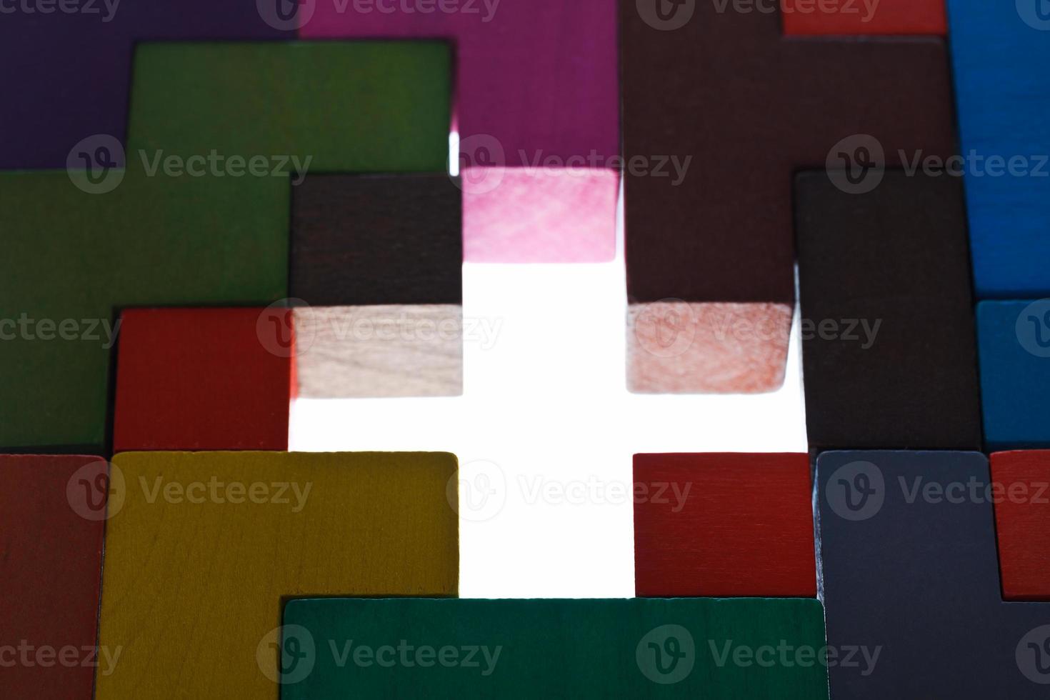 illuminated cross shape hole in wooden puzzle photo