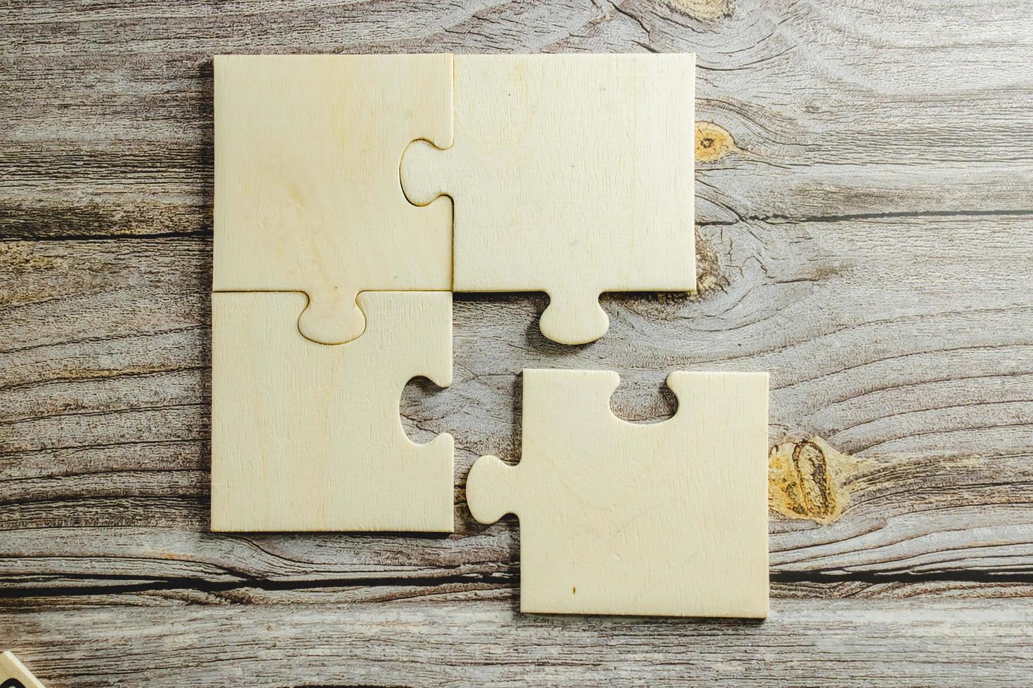 White jigsaw puzzle connecting together. Team business success partnership or teamwork concept. A group of business people assembling jigsaw puzzle. Business solutions, success and strategy concept. photo