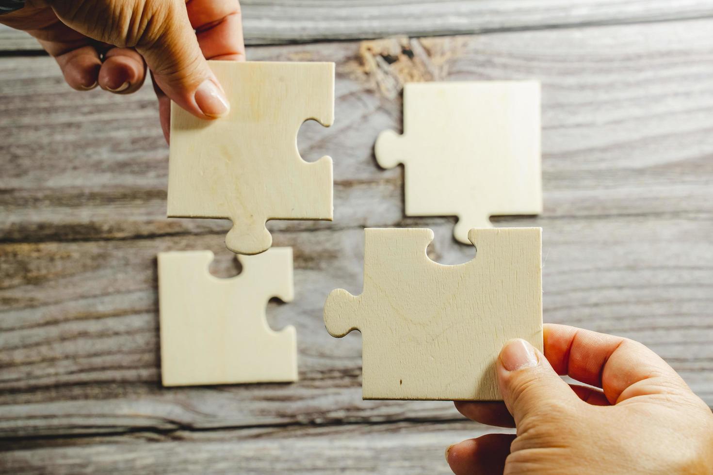 White jigsaw puzzle connecting together. Team business success partnership or teamwork concept. A group of business people assembling jigsaw puzzle. Business solutions, success and strategy concept. photo