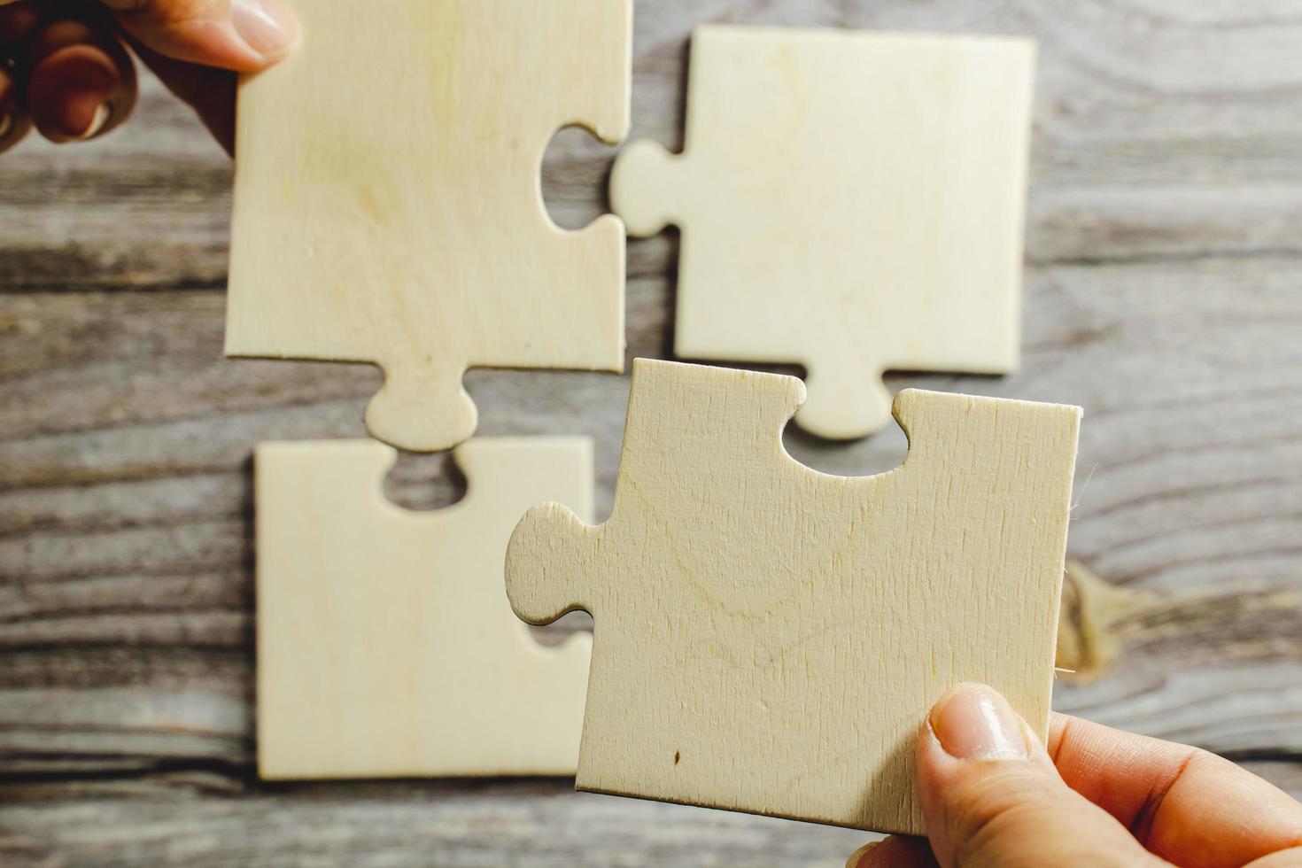 White jigsaw puzzle connecting together. Team business success partnership or teamwork concept. A group of business people assembling jigsaw puzzle. Business solutions, success and strategy concept. photo
