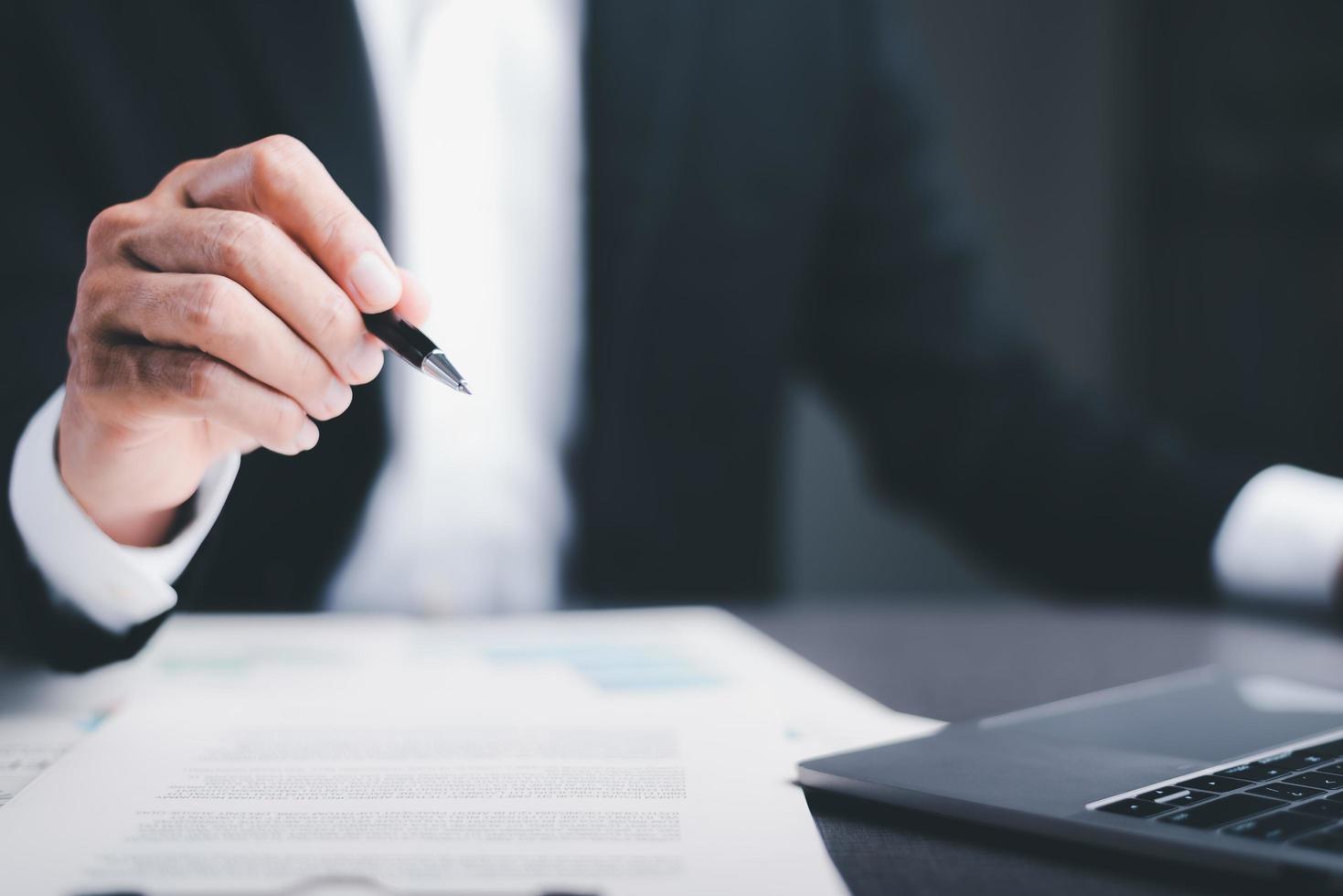 Success Goal Concepts Through Strategic Planning and Management Efficient business growth analysis and financial investment opportunity development businessman holding a pen and checking documents photo