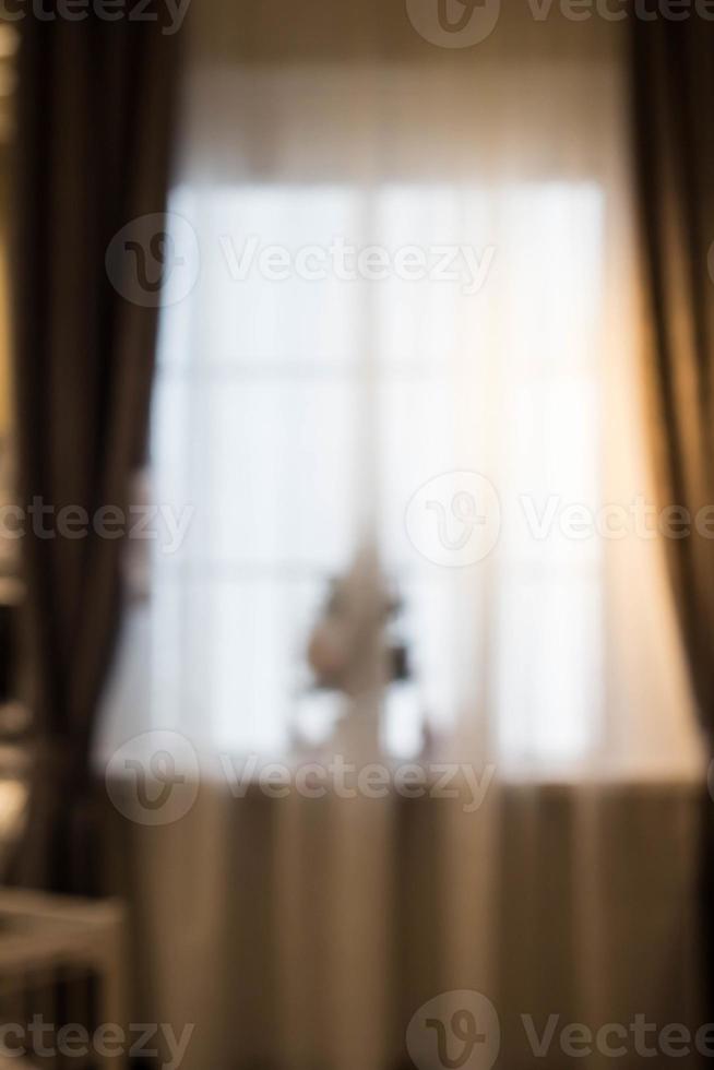 Abstract and blurry image of window with curtains with fir tree photo