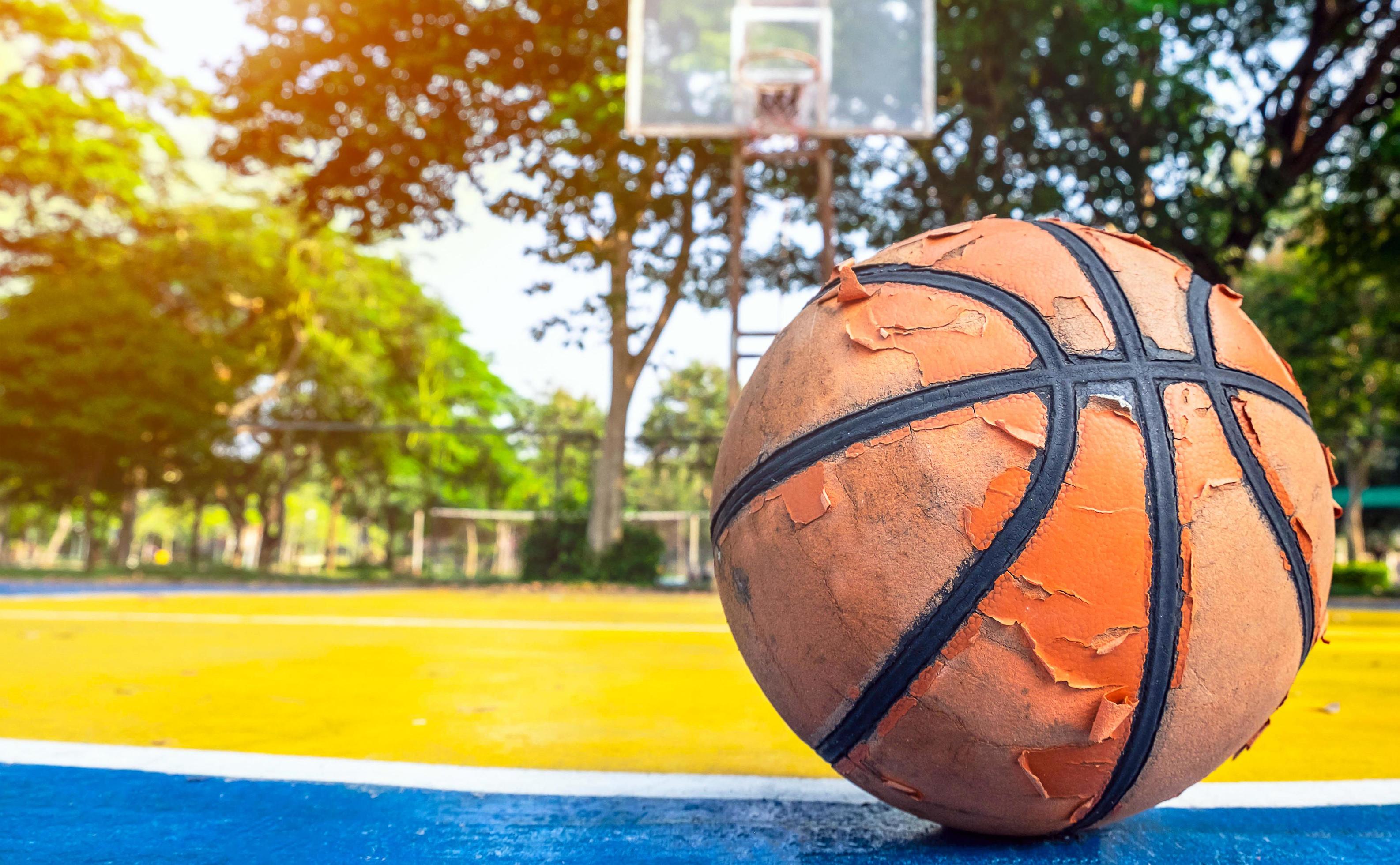 Old basketball that have already been used in the yellow basketball
