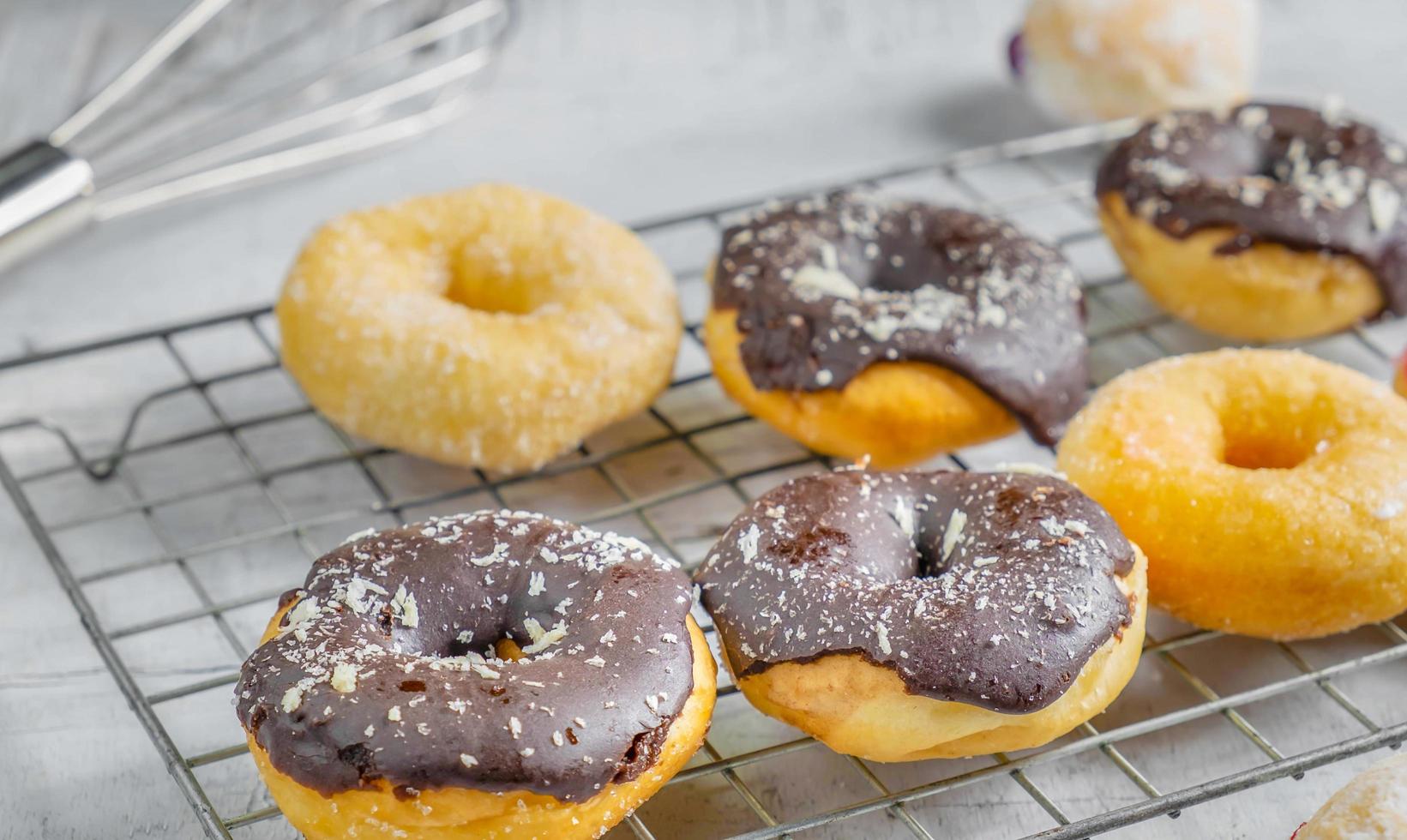 Chocolate donuts and pink donuts on the kitchen table photo