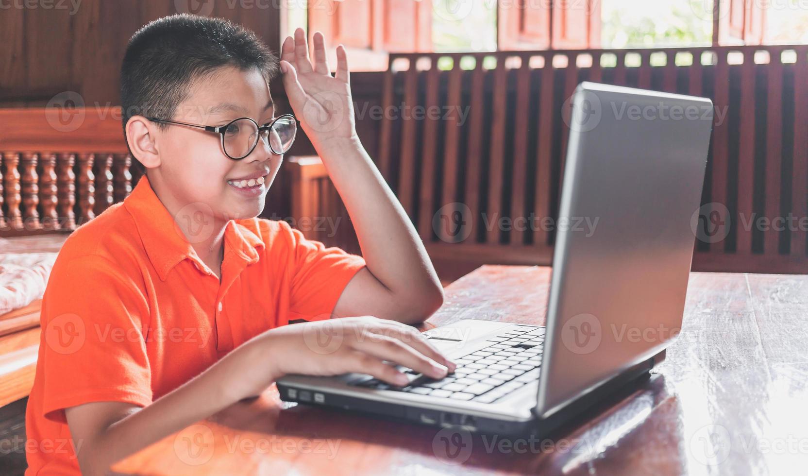 Asian boys happy and fun student online learning class study online video call and chat at home photo