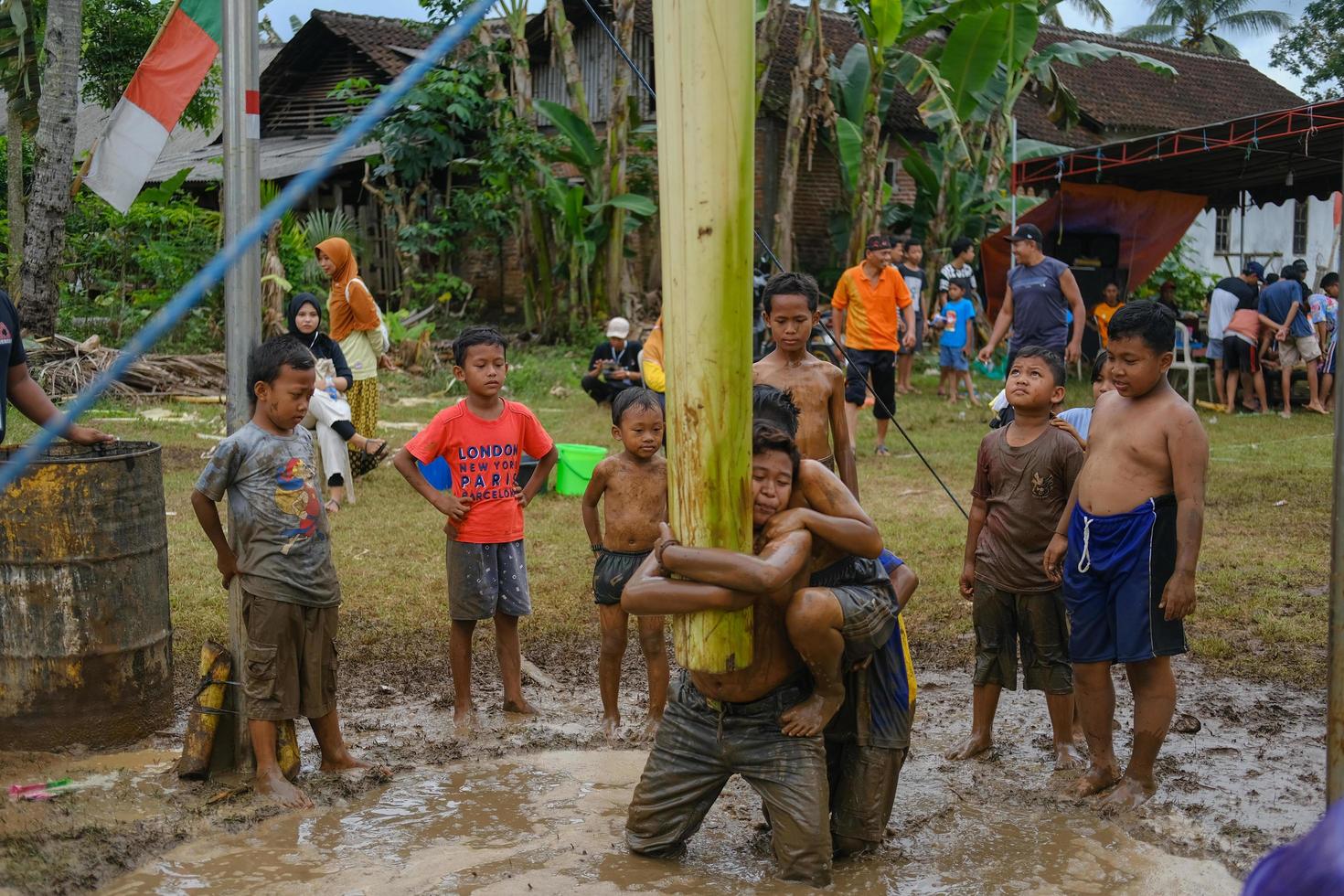 Blitar, Indonesia - September 11, 2022. Some children are ready to take part in a banana tree climbing competition to commemorate Indonesian Independence in Blitar photo