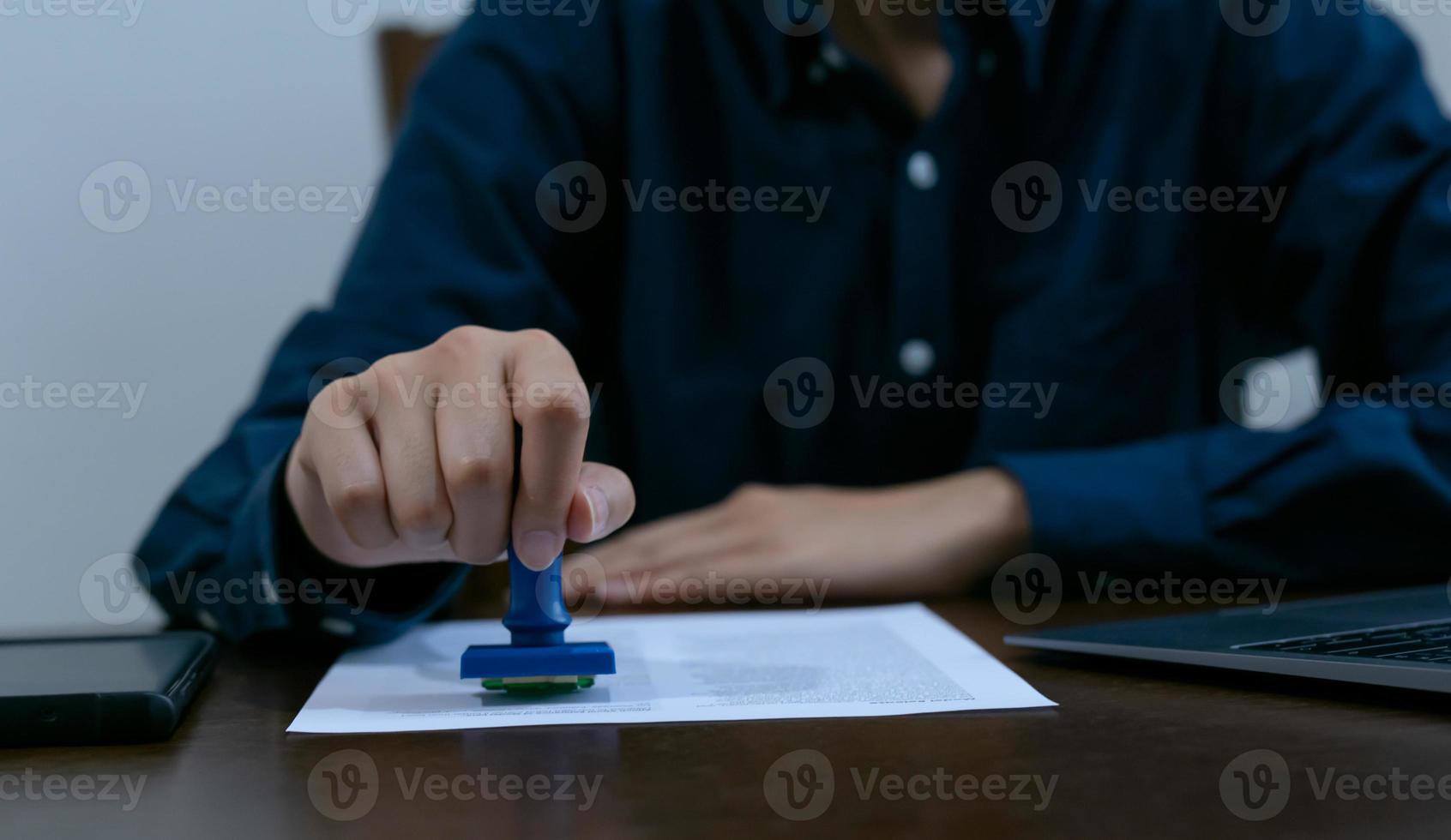 Professional businessperson notary stamp success on the document at desk, law or accounting confirmation concept. photo