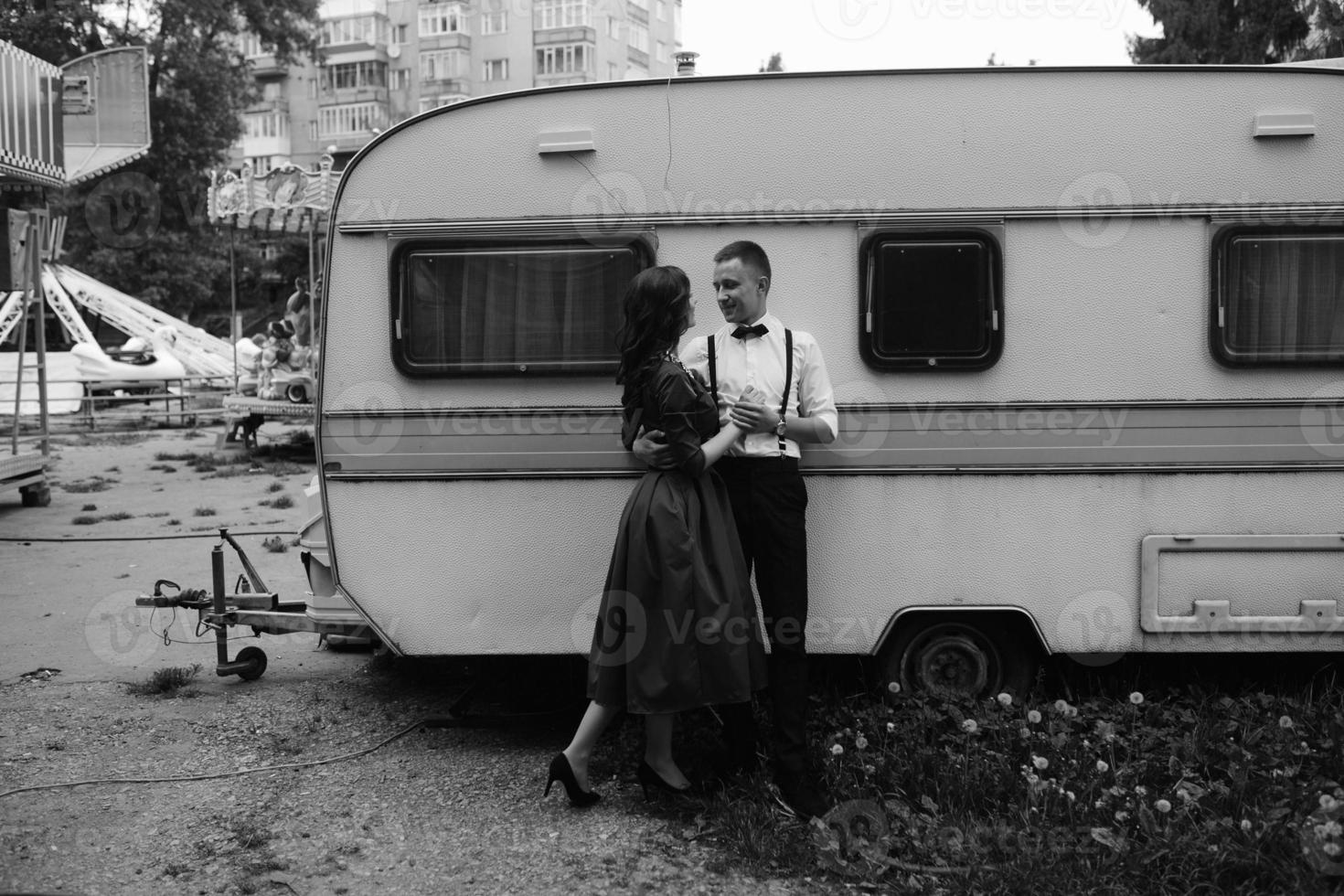 man and woman is hidden from view behind a trailer photo