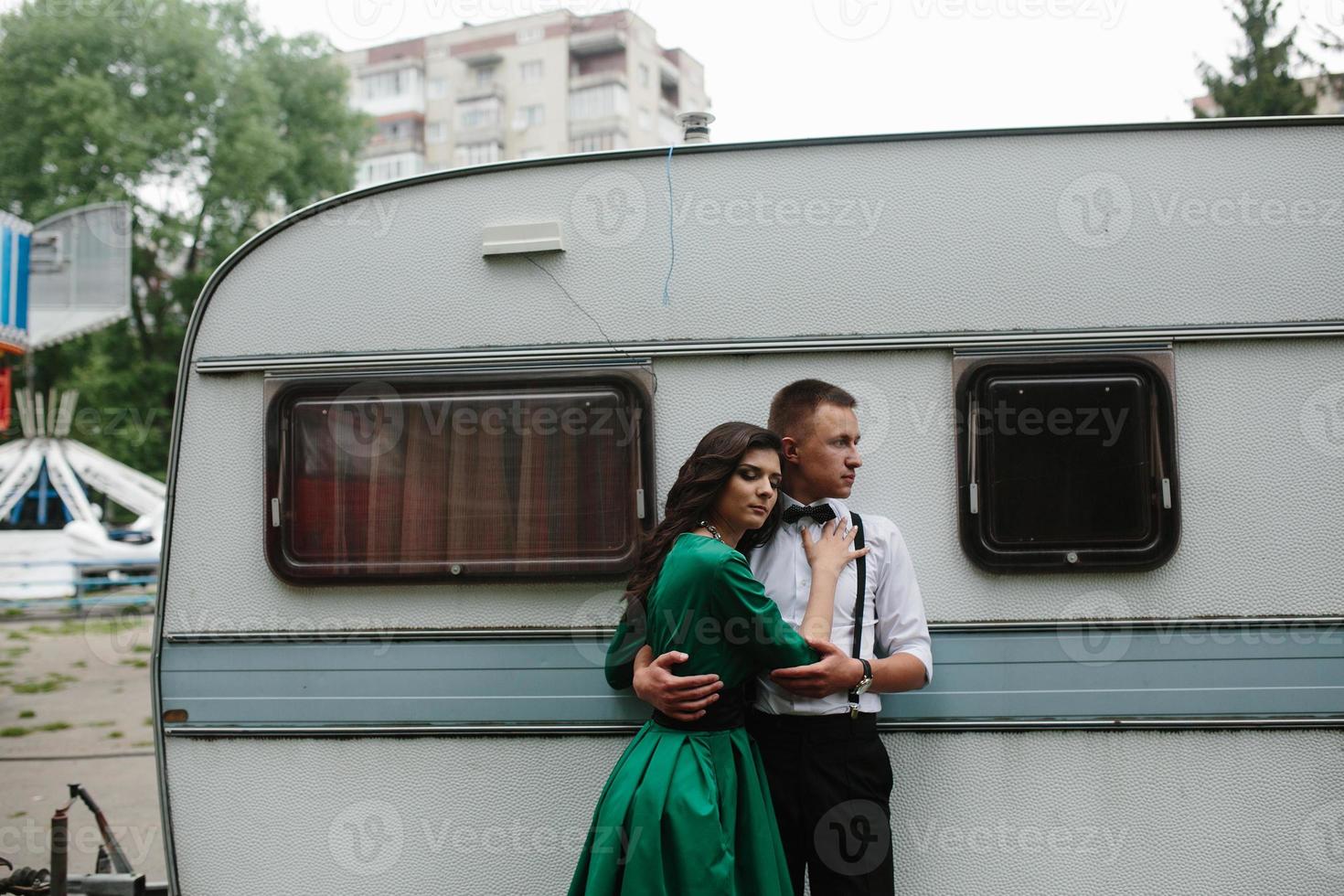 man and woman is hidden from view behind a trailer photo