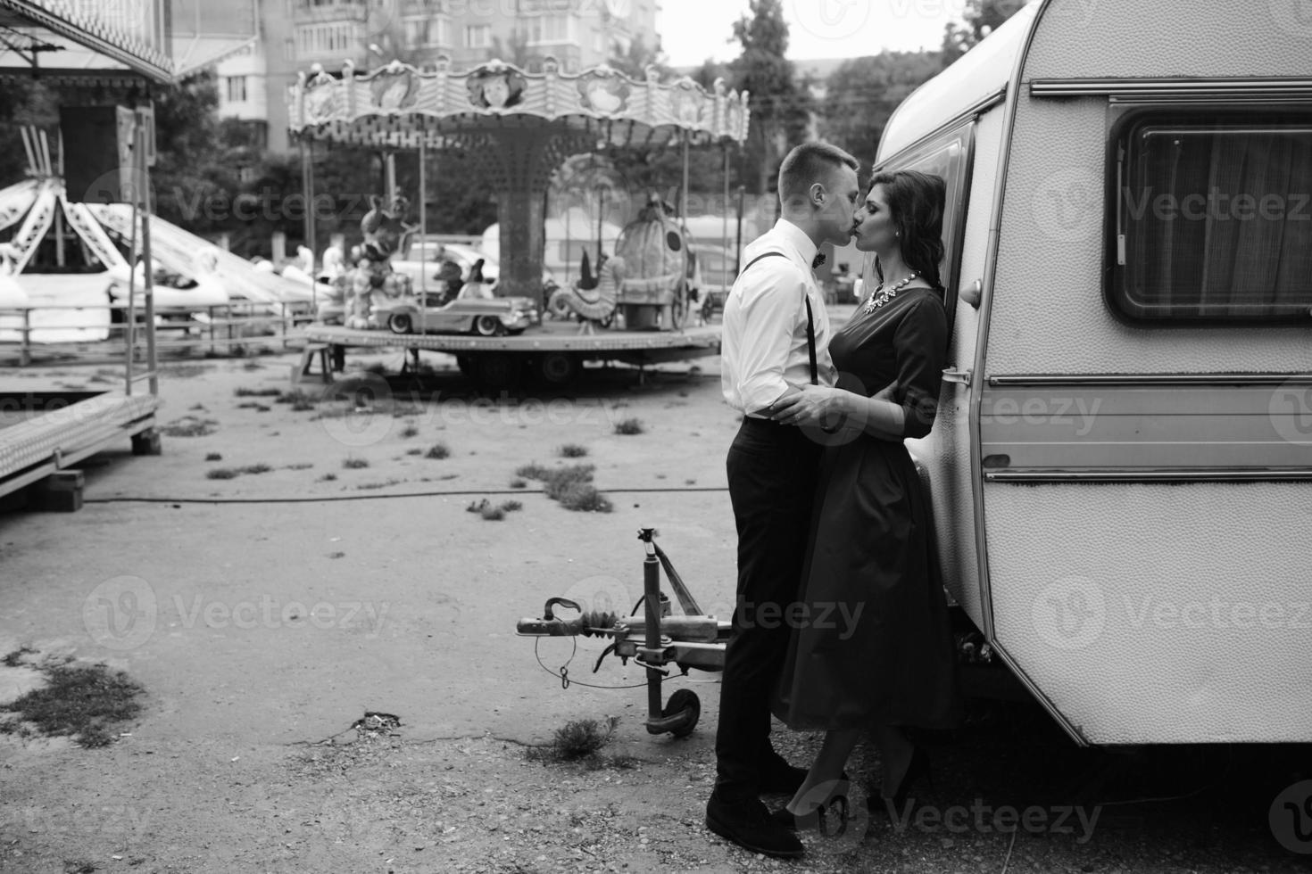 man and woman is hidden from view behind a trailer photo