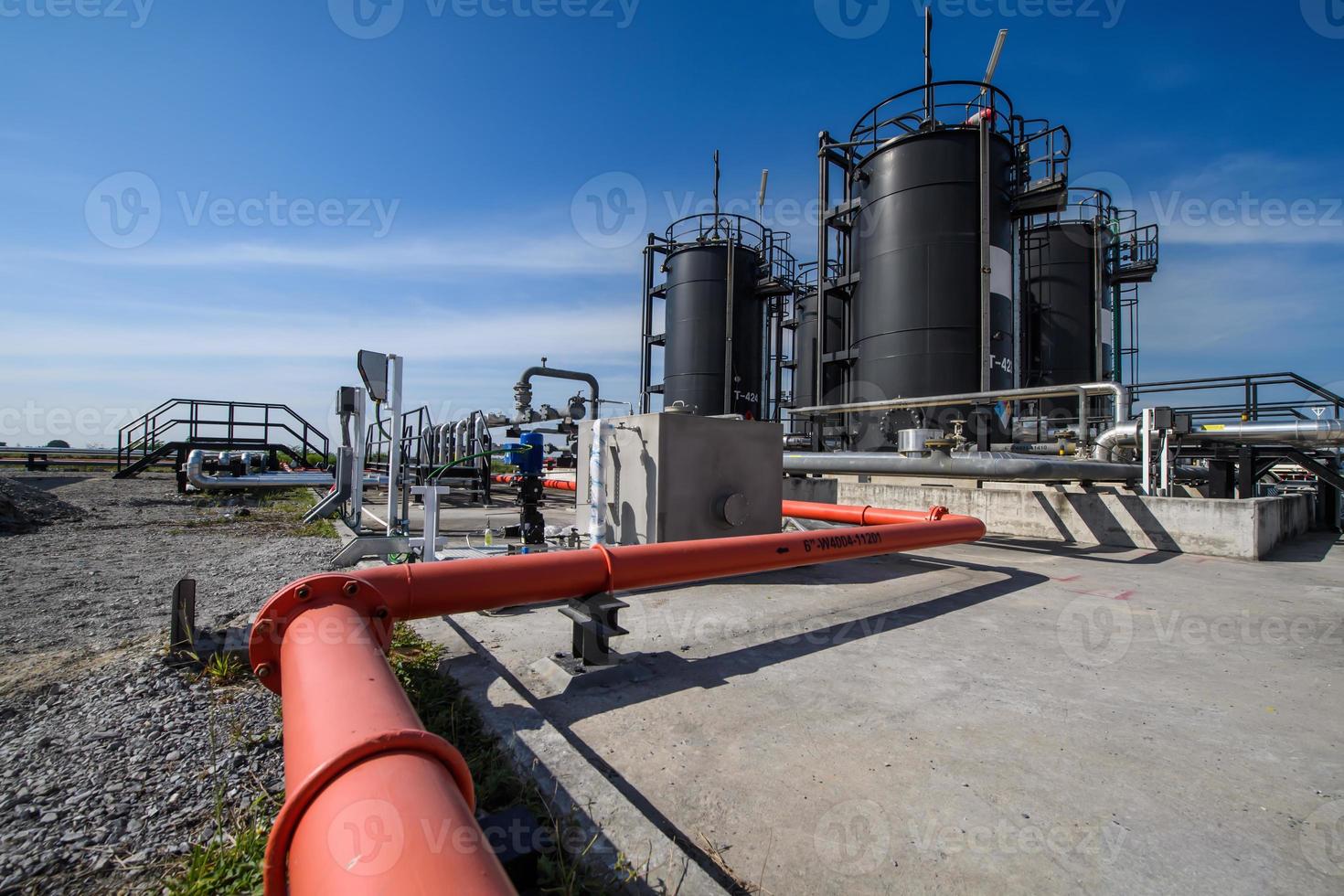 zona industrial, tuberías de acero, válvulas, tanque de aceite, cables y pasarelas foto