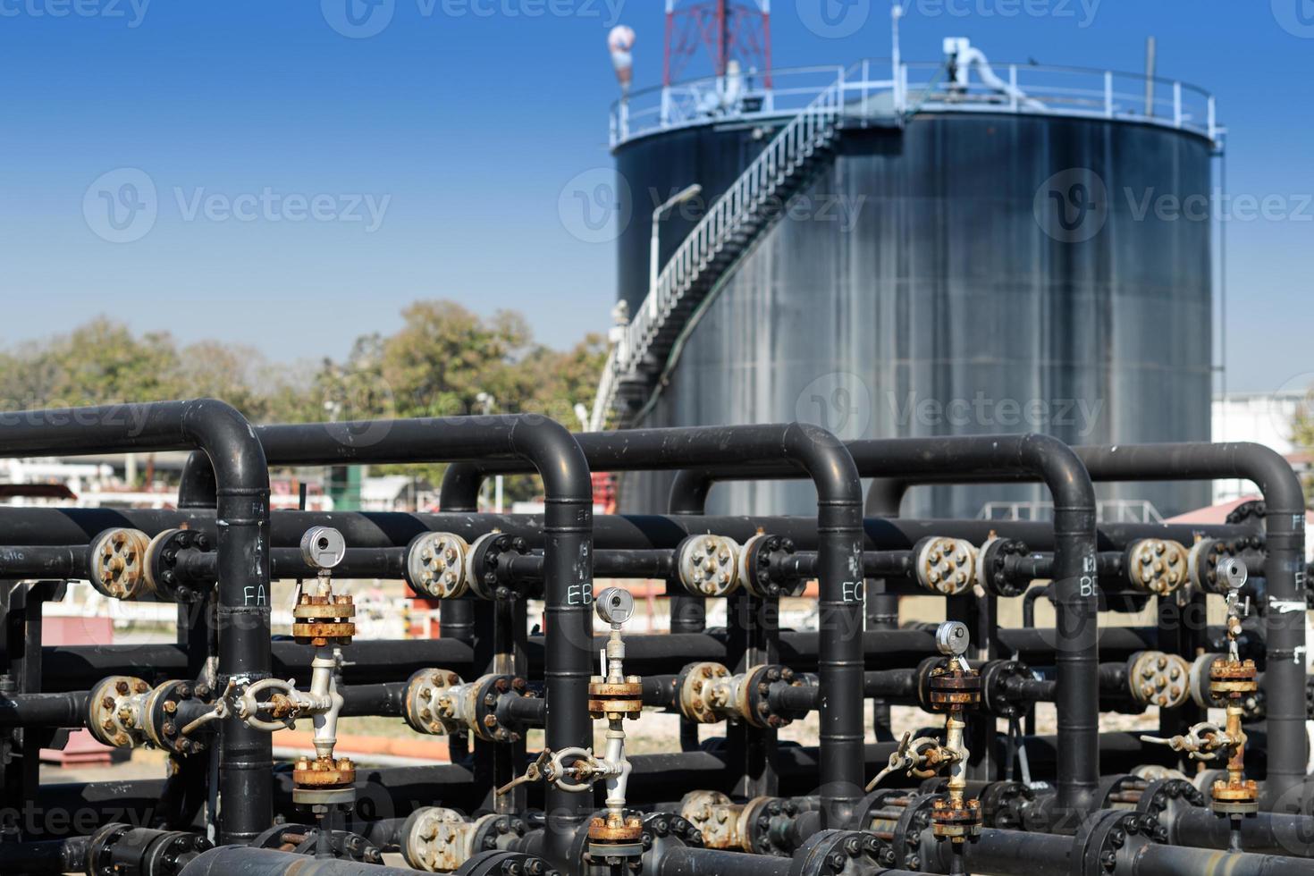 Industrial zone, Steel pipelines, valves, oil tank, cables and walkways photo