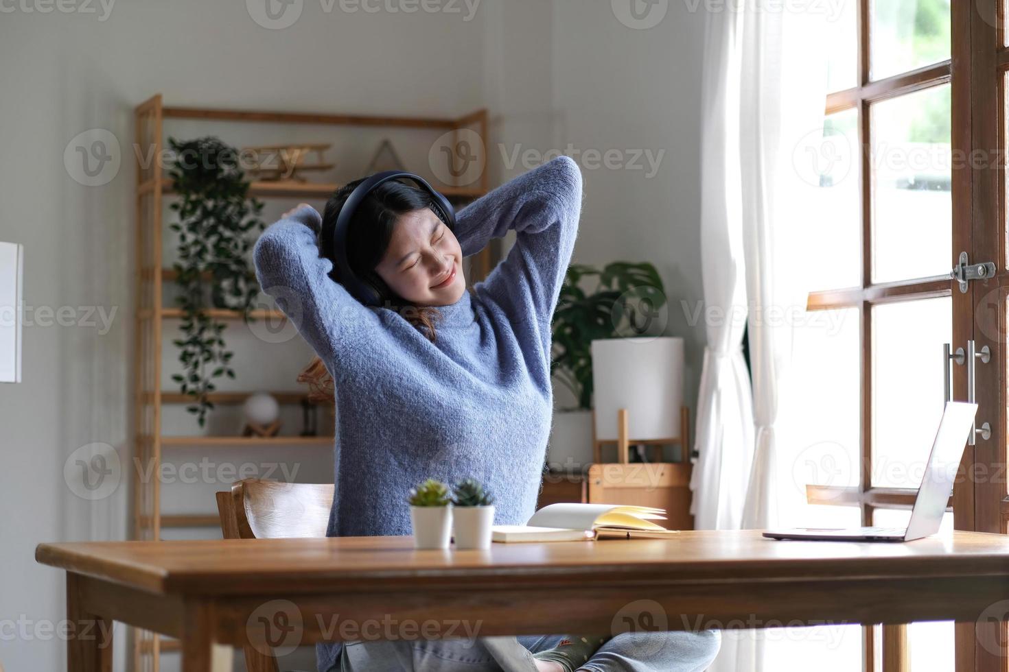 Young attractive asian female   relax cross arm behind head use notebook digital online course program in quarantine at home reskill upskill school class for career path. photo