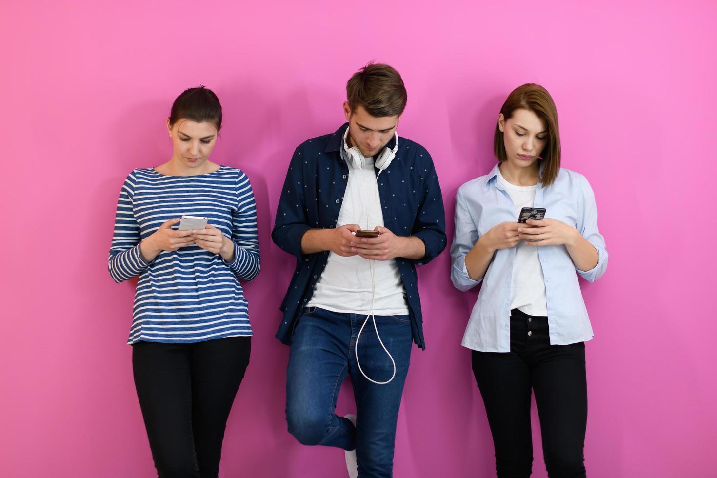 group of friends have fun and dance while using a cell phone and headphones photo