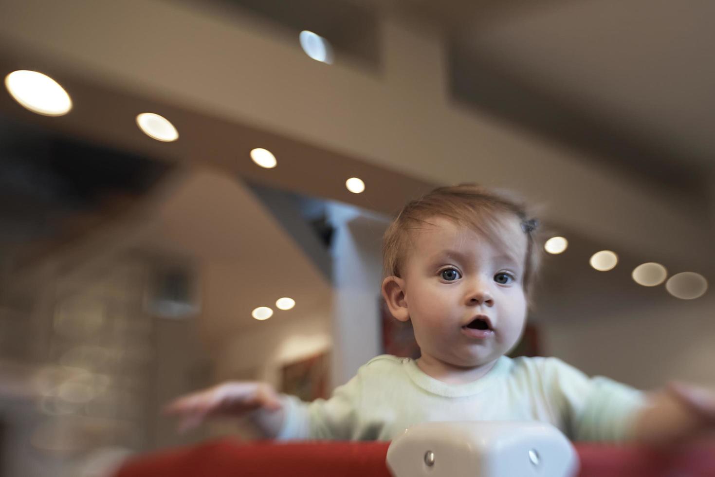 cute  little  baby playing in mobile  bed photo