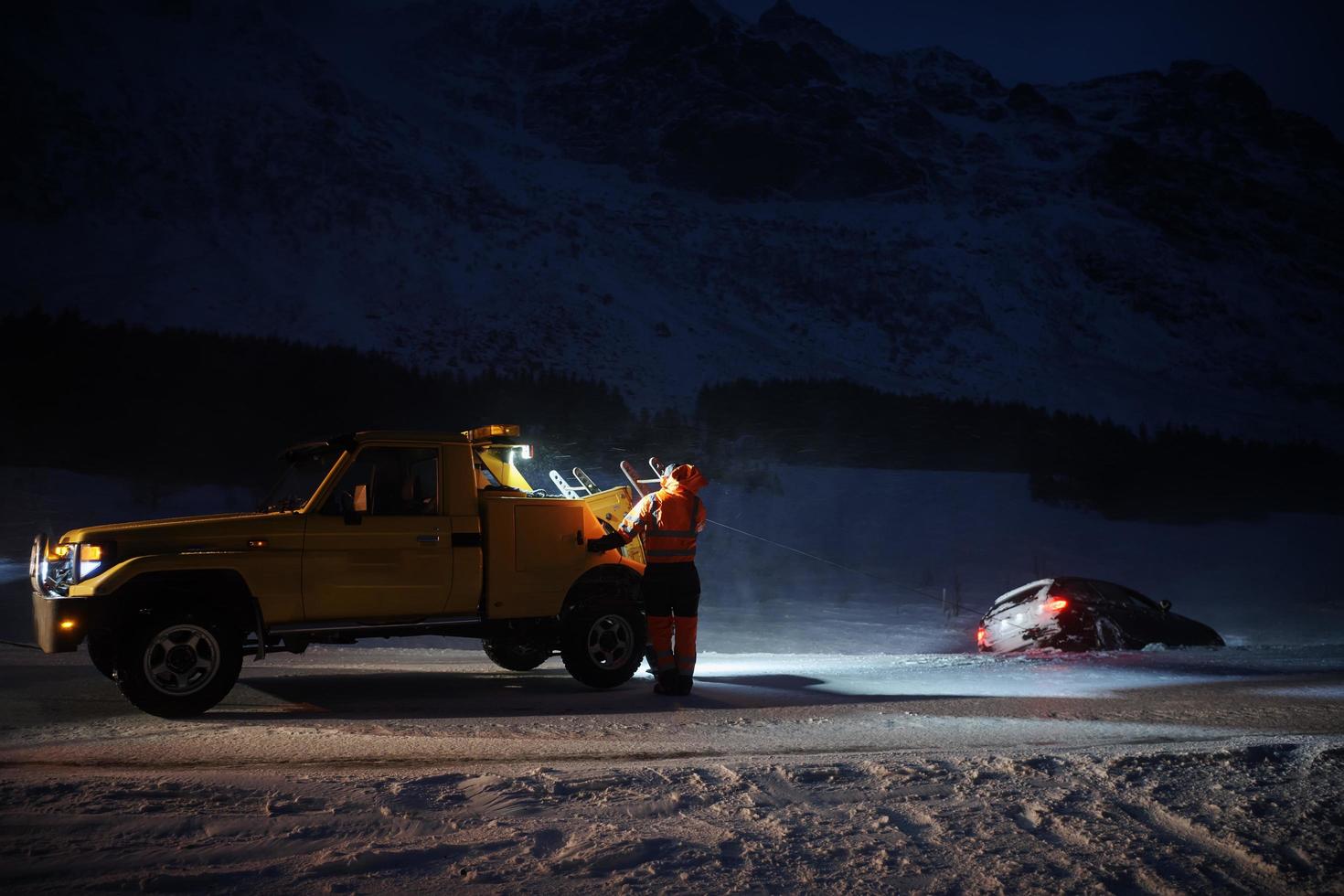 Car being towed after accident in snow storm photo