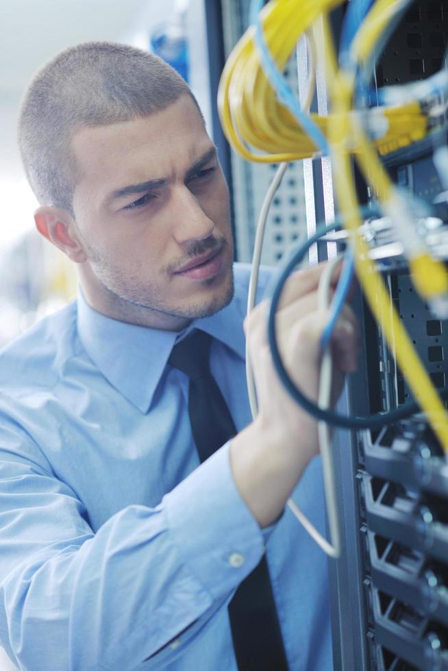 young it engeneer in datacenter server room photo