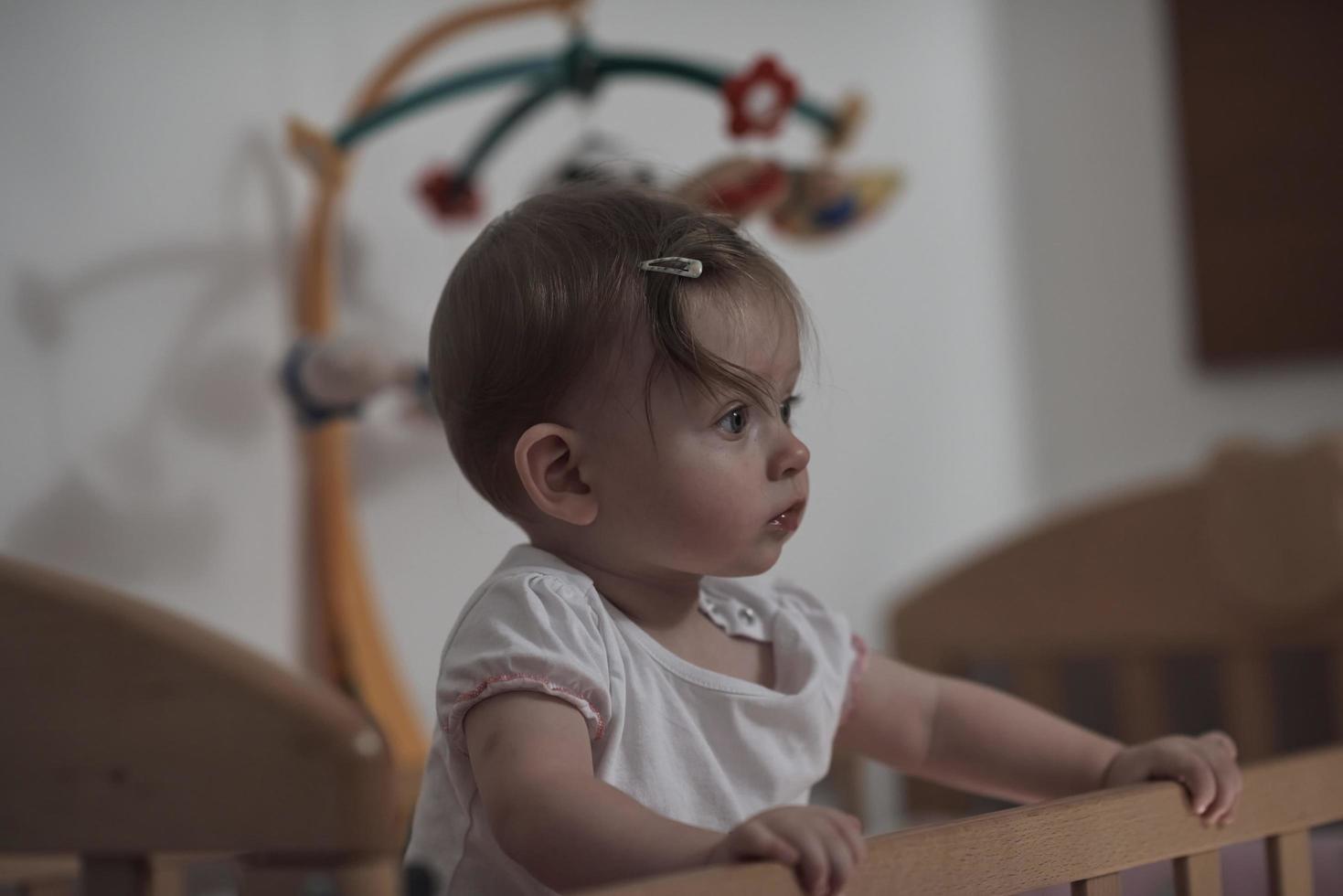 cute  little one year old baby and making first steps in bed photo