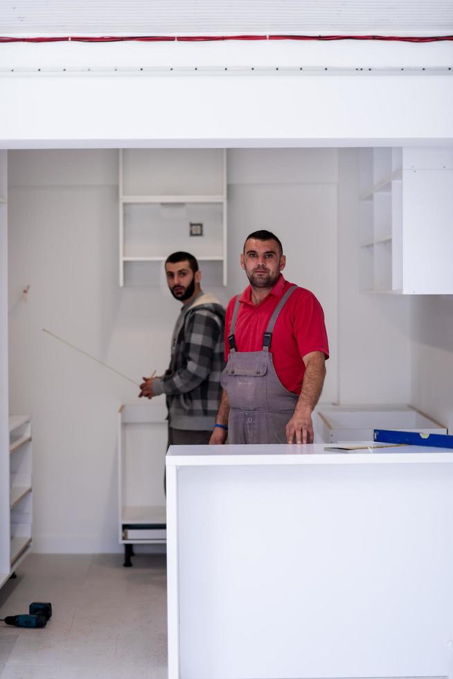 workers installing a new kitchen photo