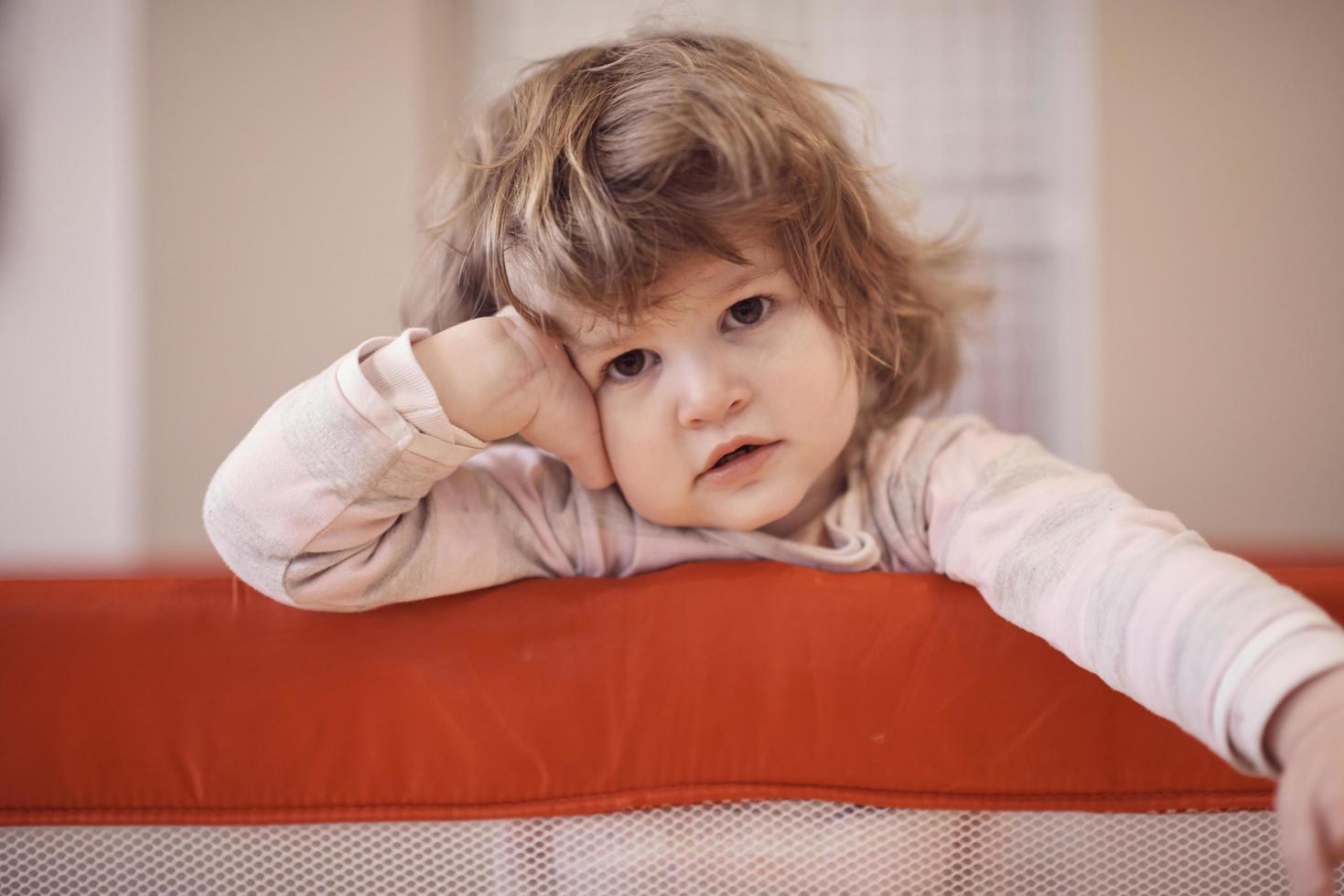 little baby girl with strange hairstyle and curlers photo