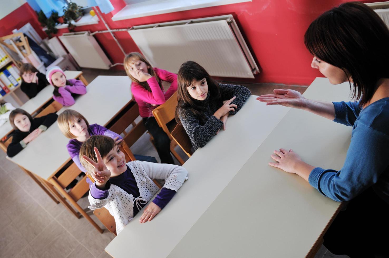 happy teacher in  school classroom photo