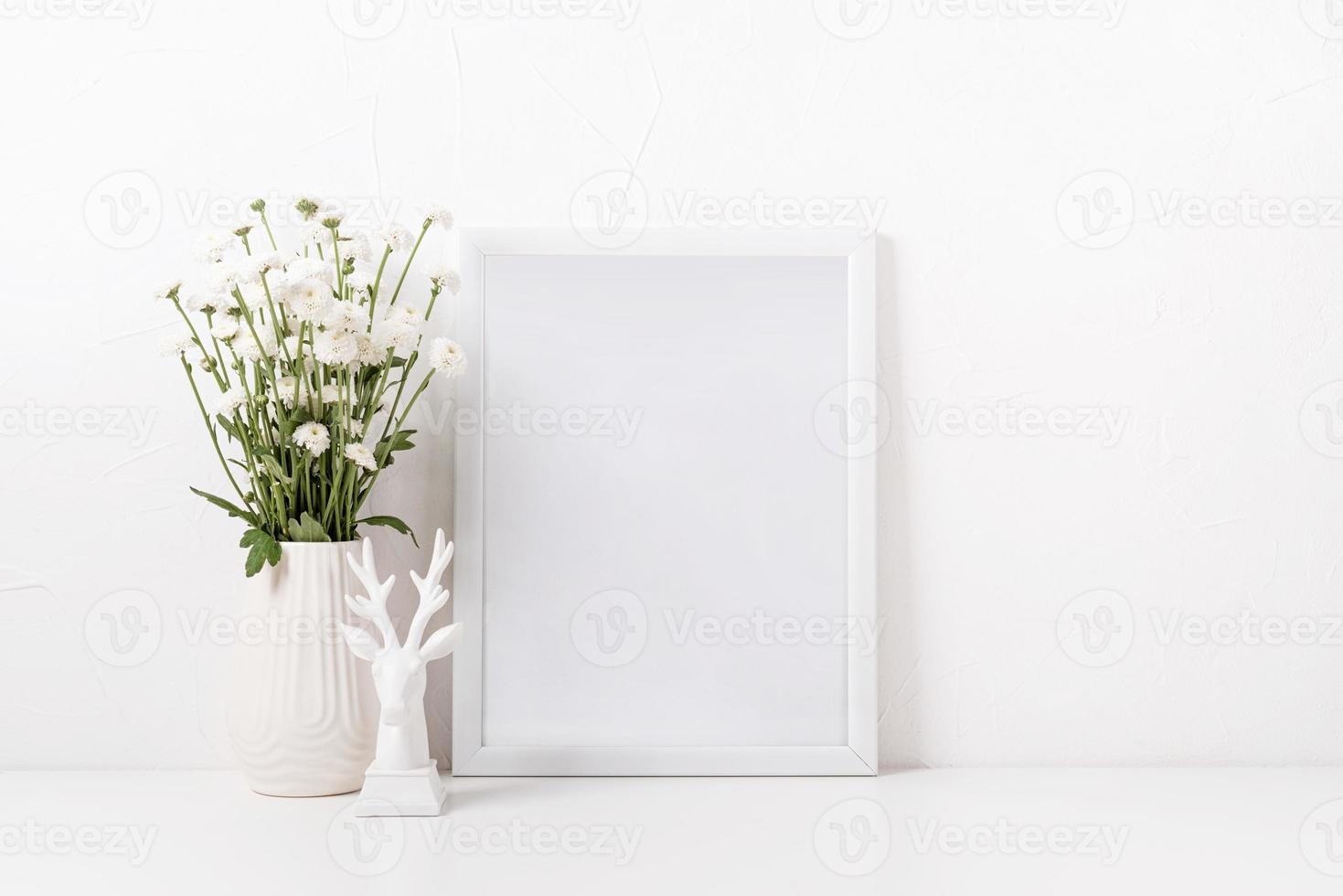 White frame mockup with chrysanthemum flowers in a vase on a white table photo