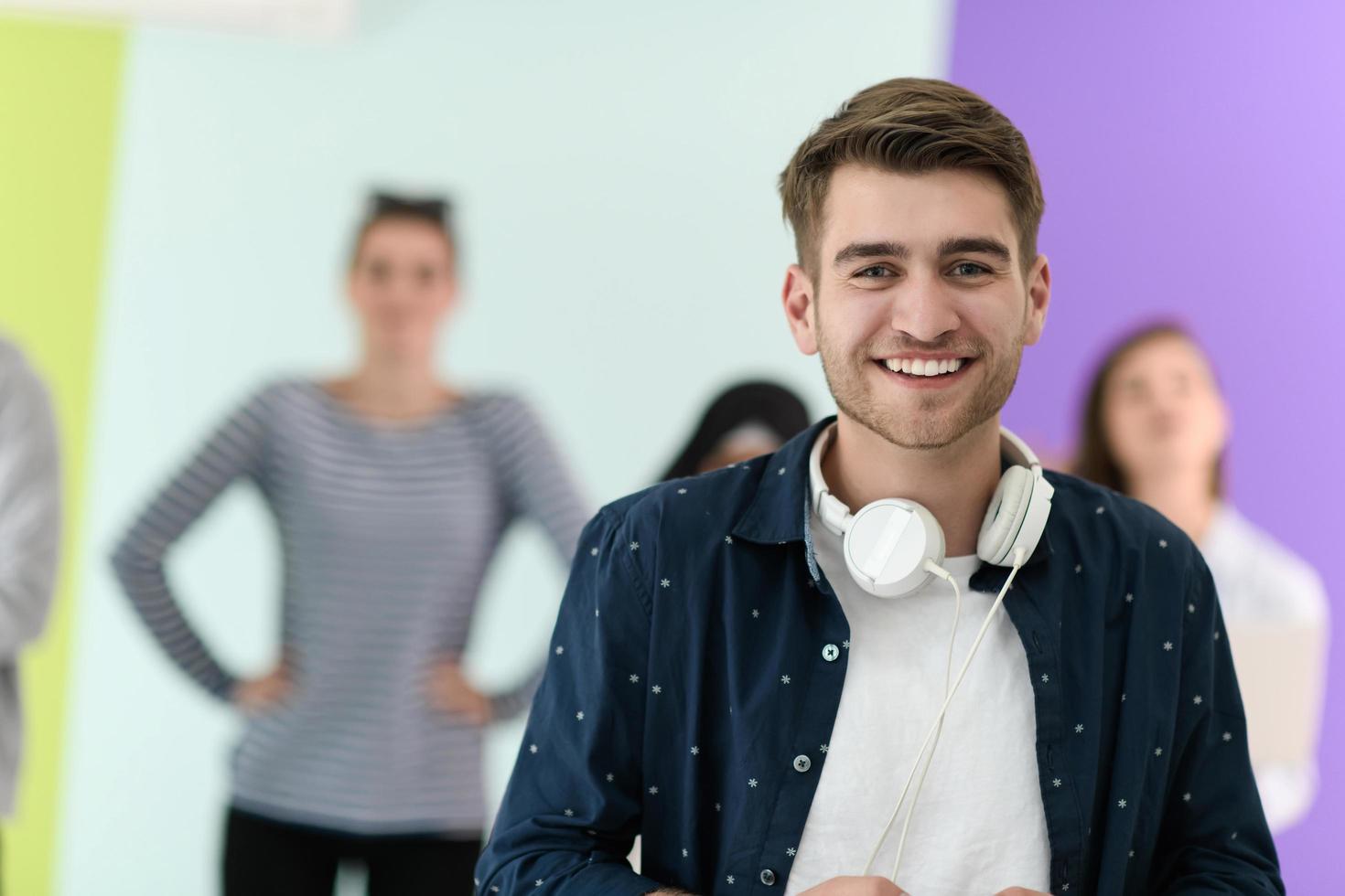 guy with the beautiful smile in the blue attractive shirt i use my cell phone and headphones photo