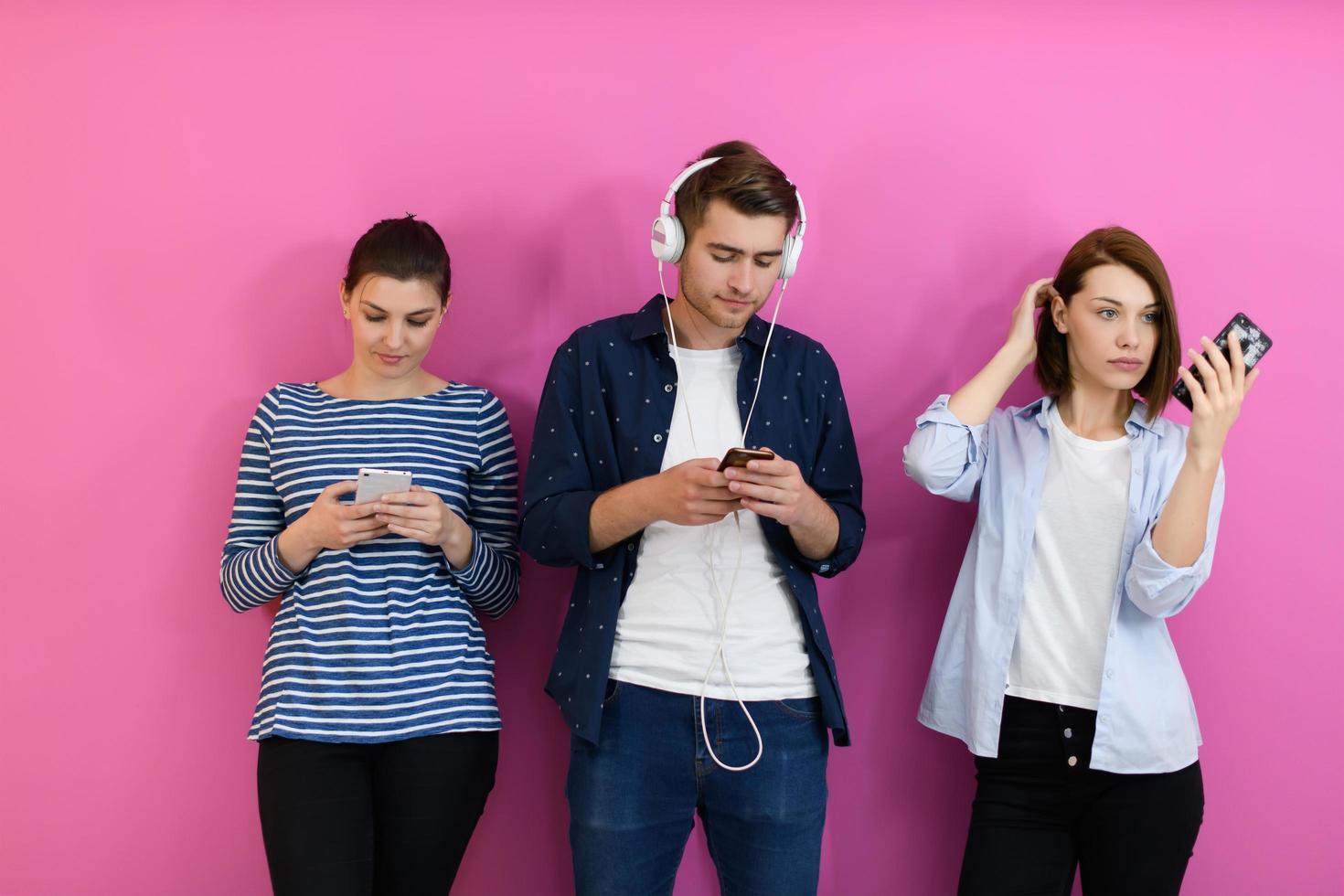 group of friends have fun and dance while using a cell phone and headphones photo