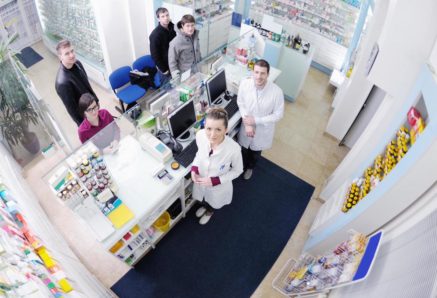 pharmacist suggesting medical drug to buyer in pharmacy drugstore photo