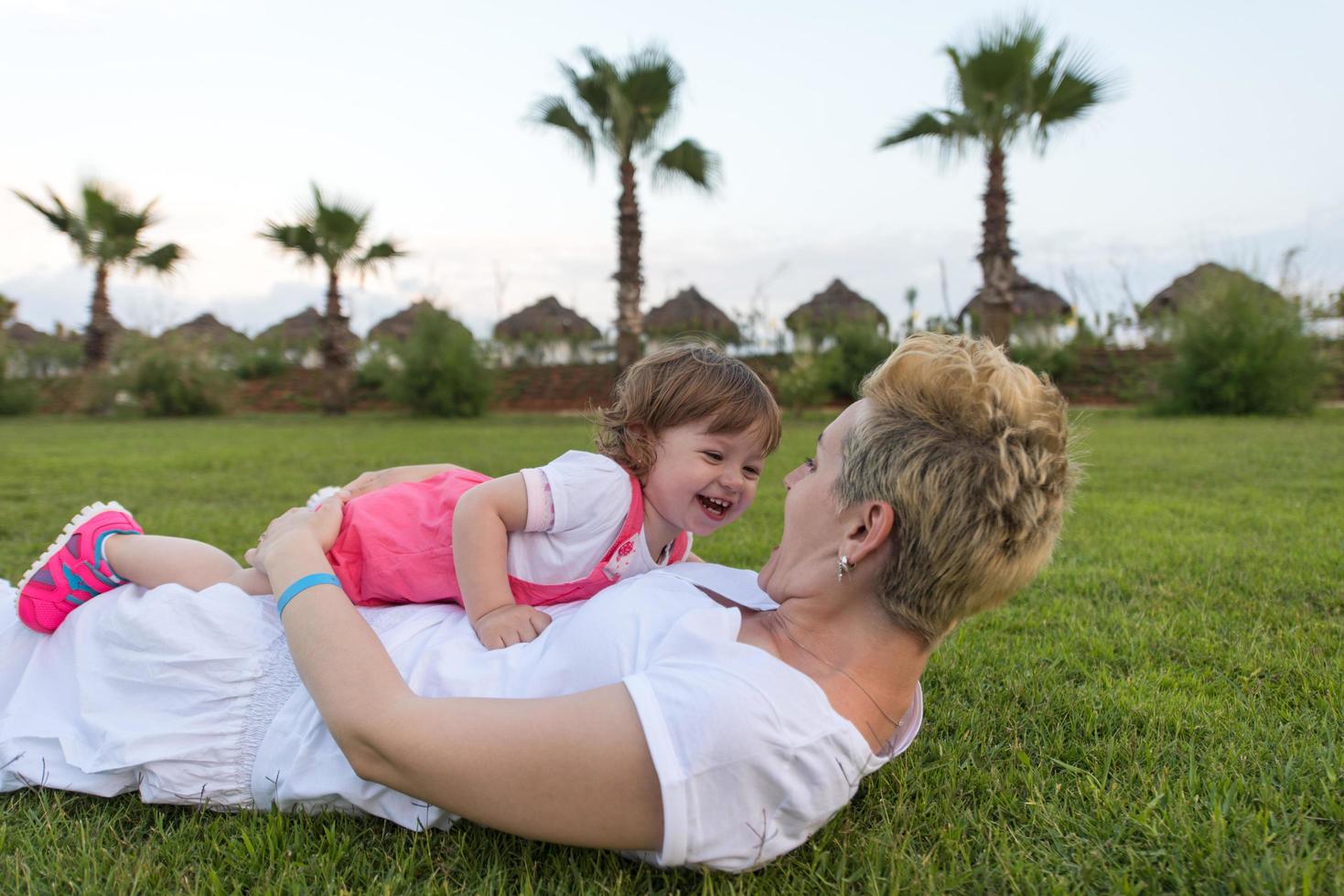 mother and little daughter playing at backyard photo