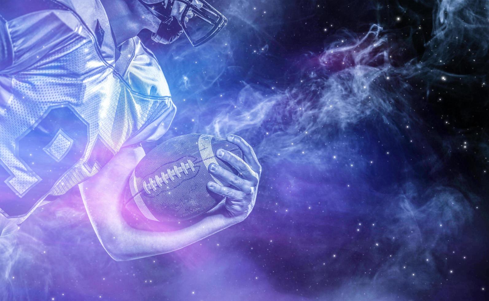 American football player holding ball while running on field photo