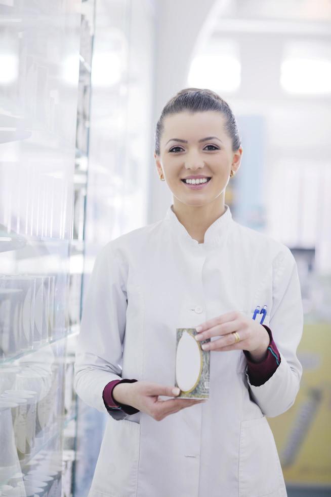 pharmacist chemist woman standing in pharmacy drugstore photo
