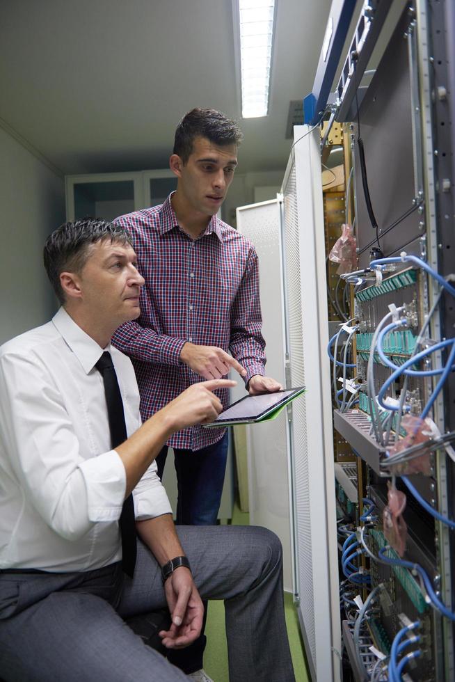 network engineers in server room photo