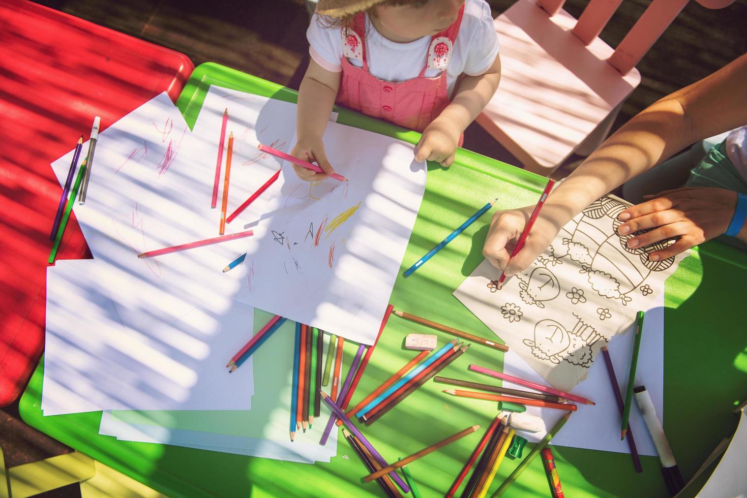 mom and little daughter drawing a colorful pictures photo