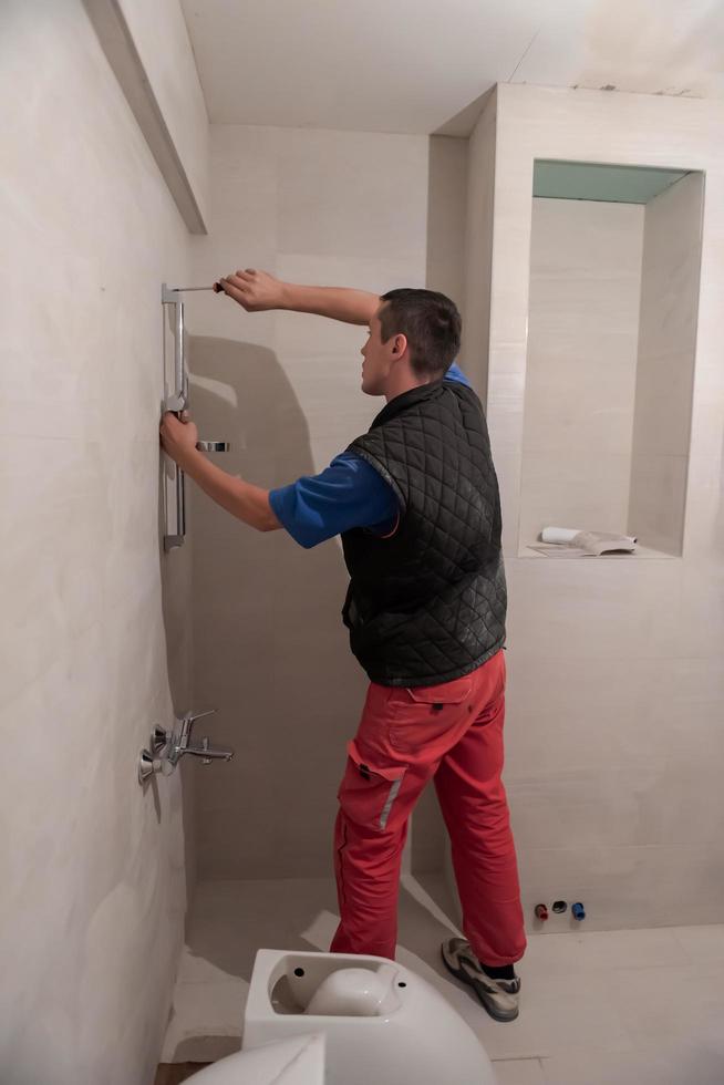professional plumber working in a bathroom photo