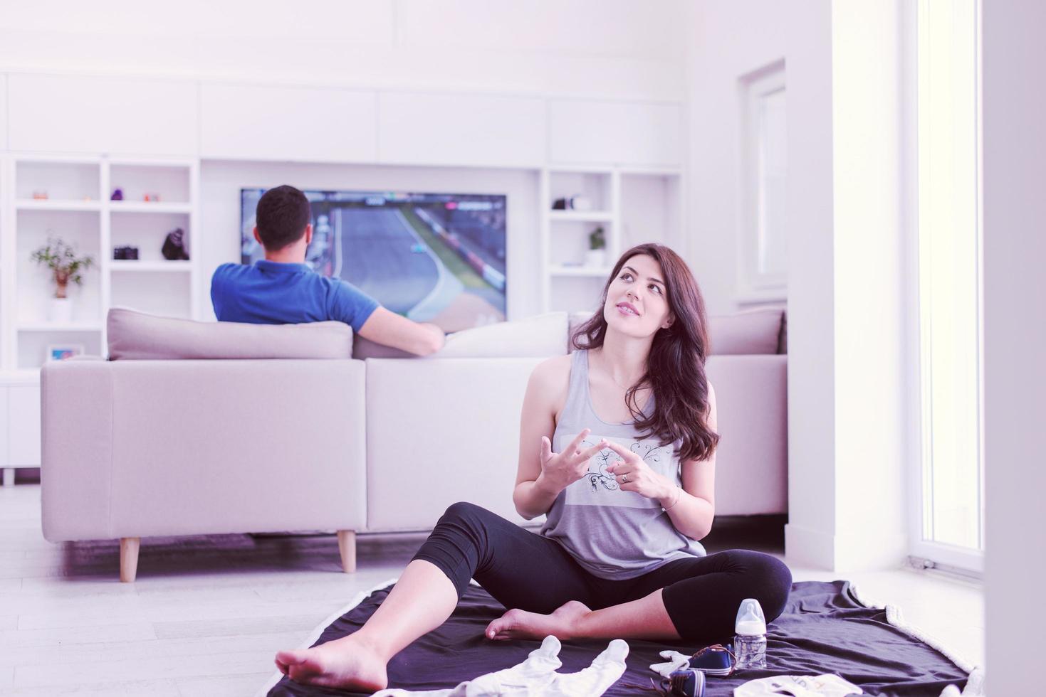 pregnant couple checking a list of things for their unborn baby photo