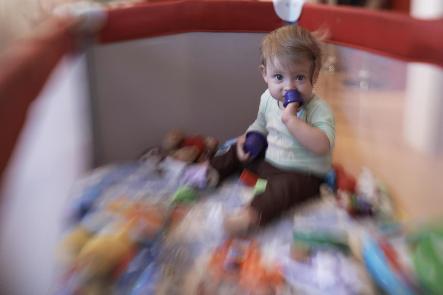 cute  little  baby playing in mobile  bed photo