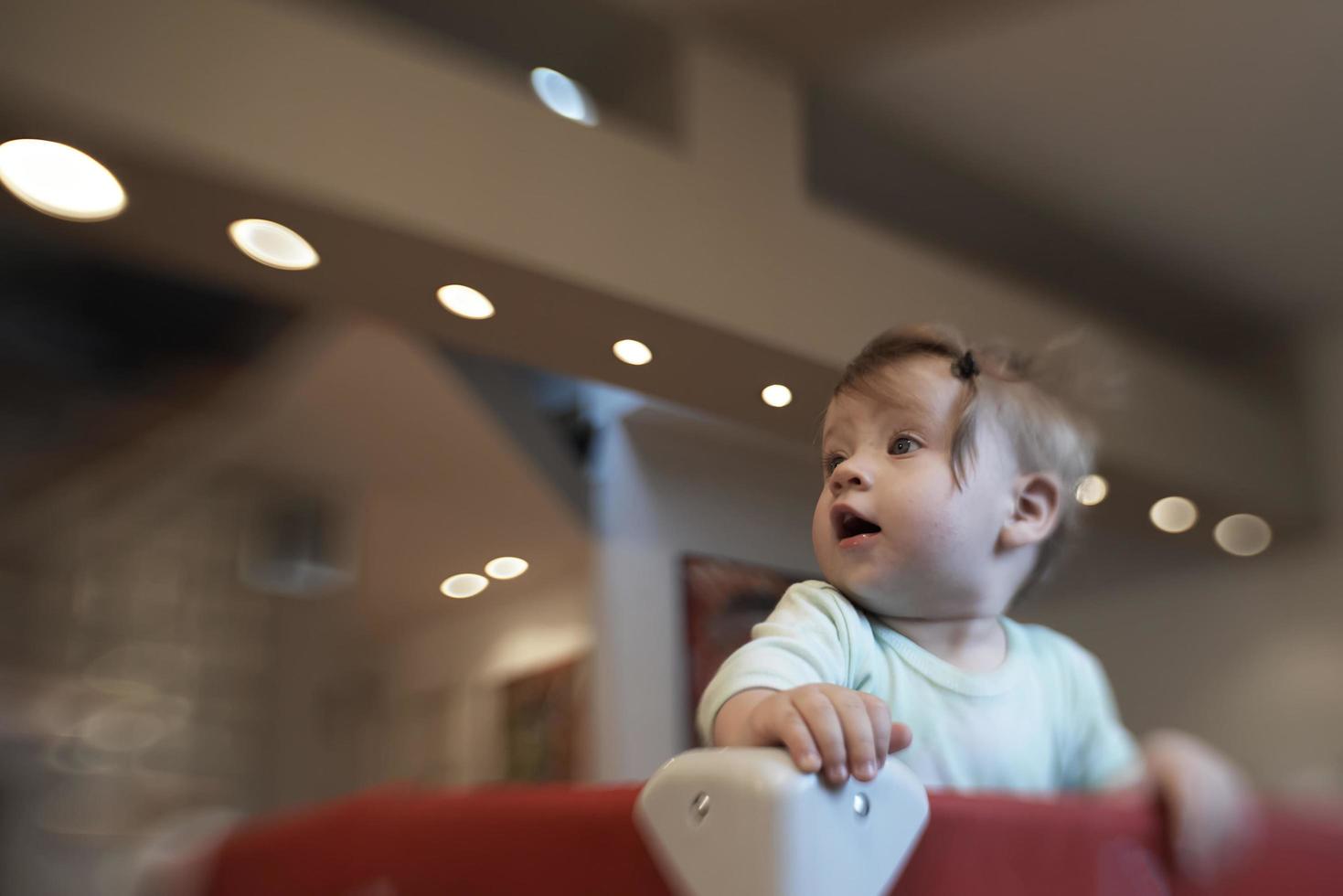cute  little  baby playing in mobile  bed photo