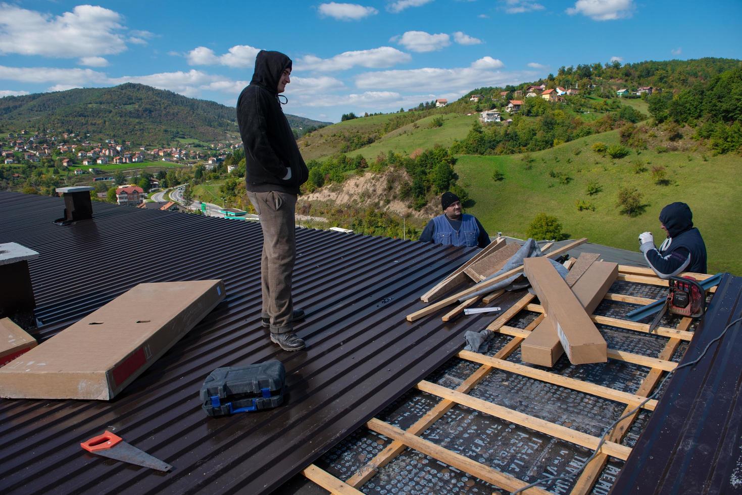 Construction worker installing a new roof photo