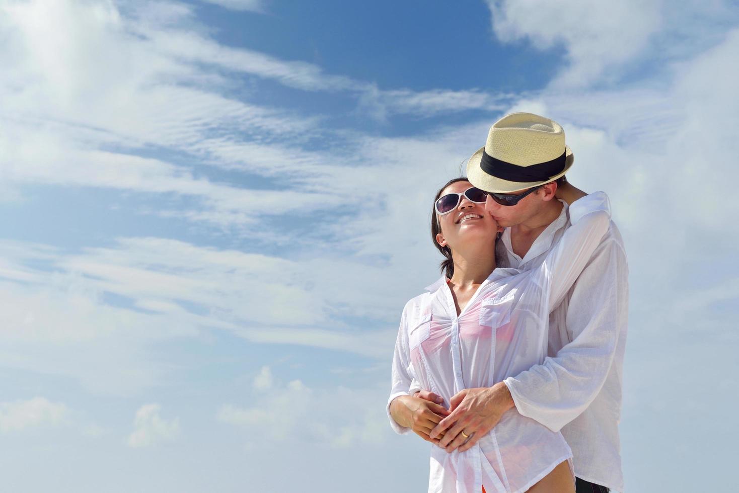happy young couple have fun on beach photo